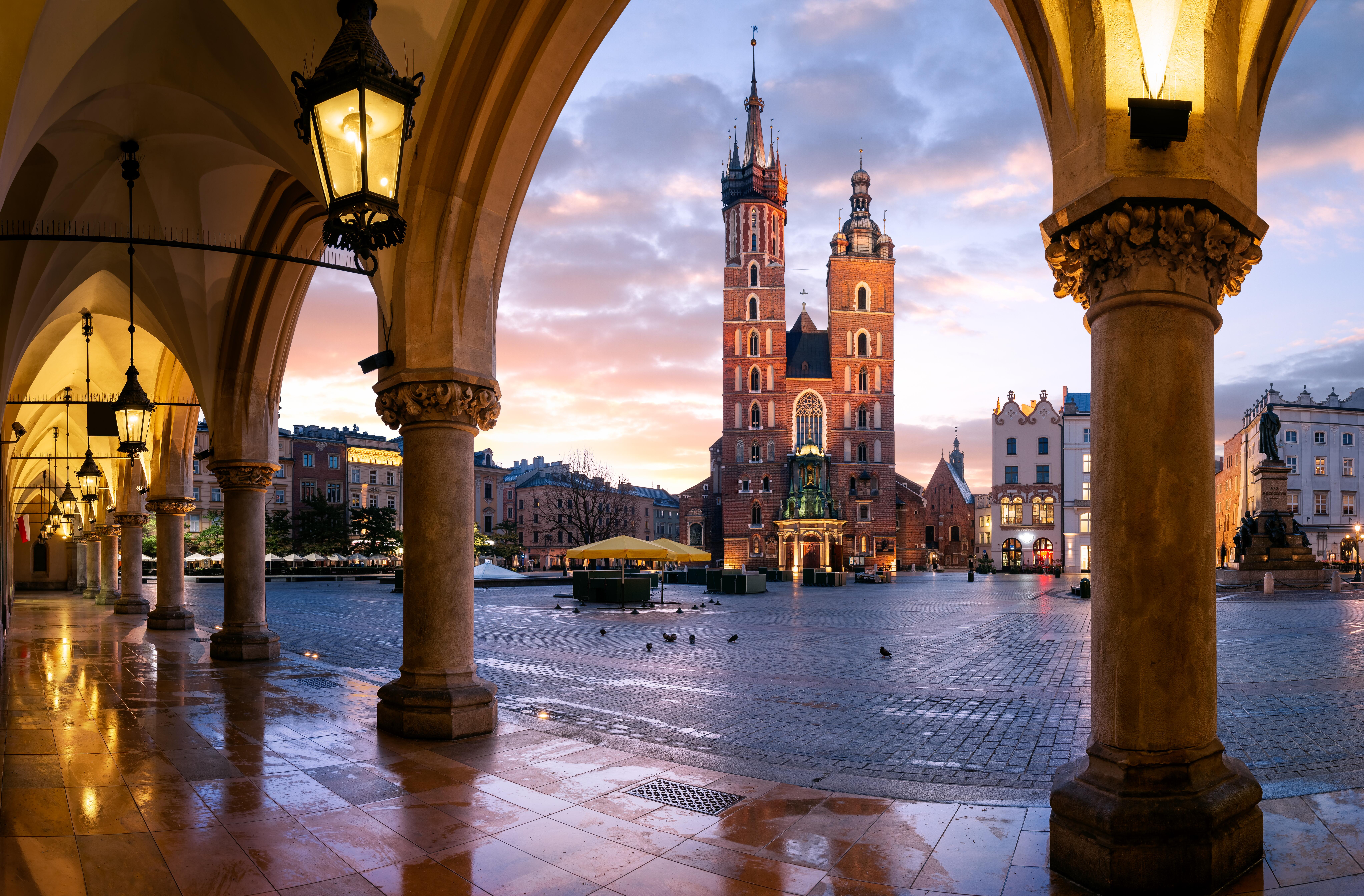 Image of St Mary's Basilica taken at sunrise through the arches of the Cloth Hall, Krakow, Poland.
