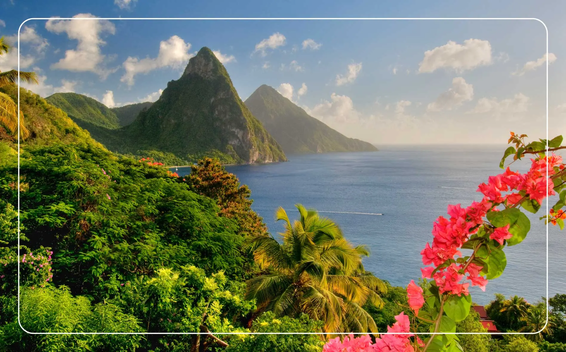 St. Lucia’s twin Pitons are surrounded by the lush tropical landscape at sunset.