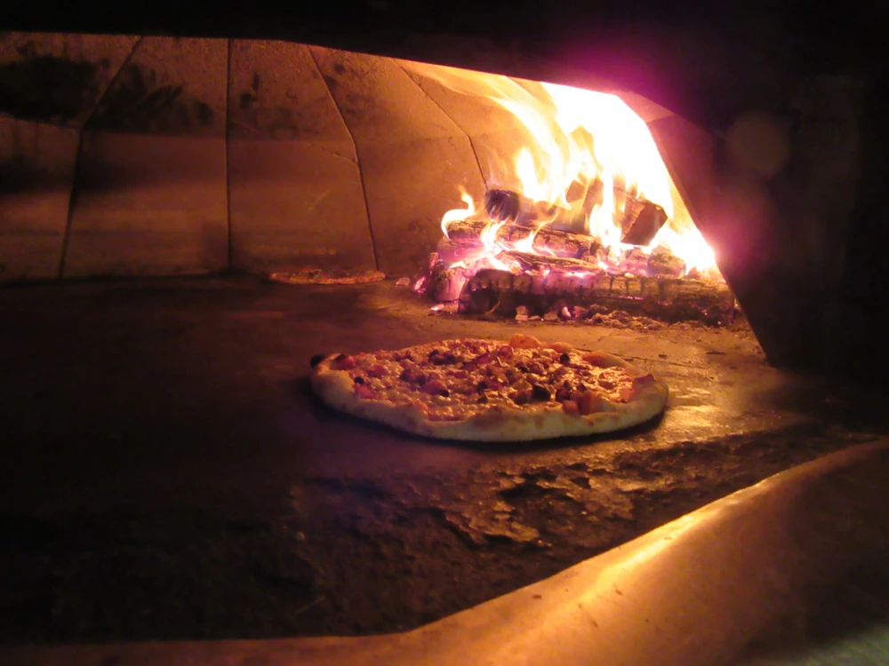 Pizza in oven at Fire Works-Wood Fired Pizza in Leesburg Virginia