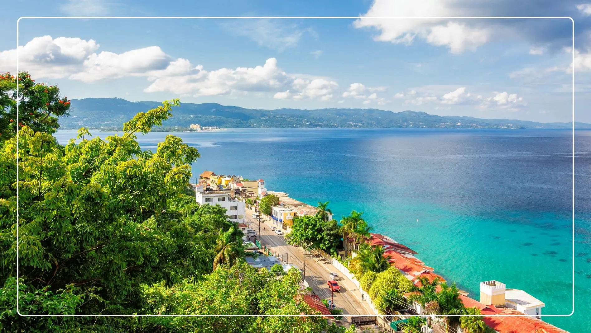 An aerial view of a street running along the coast of Jamaica.