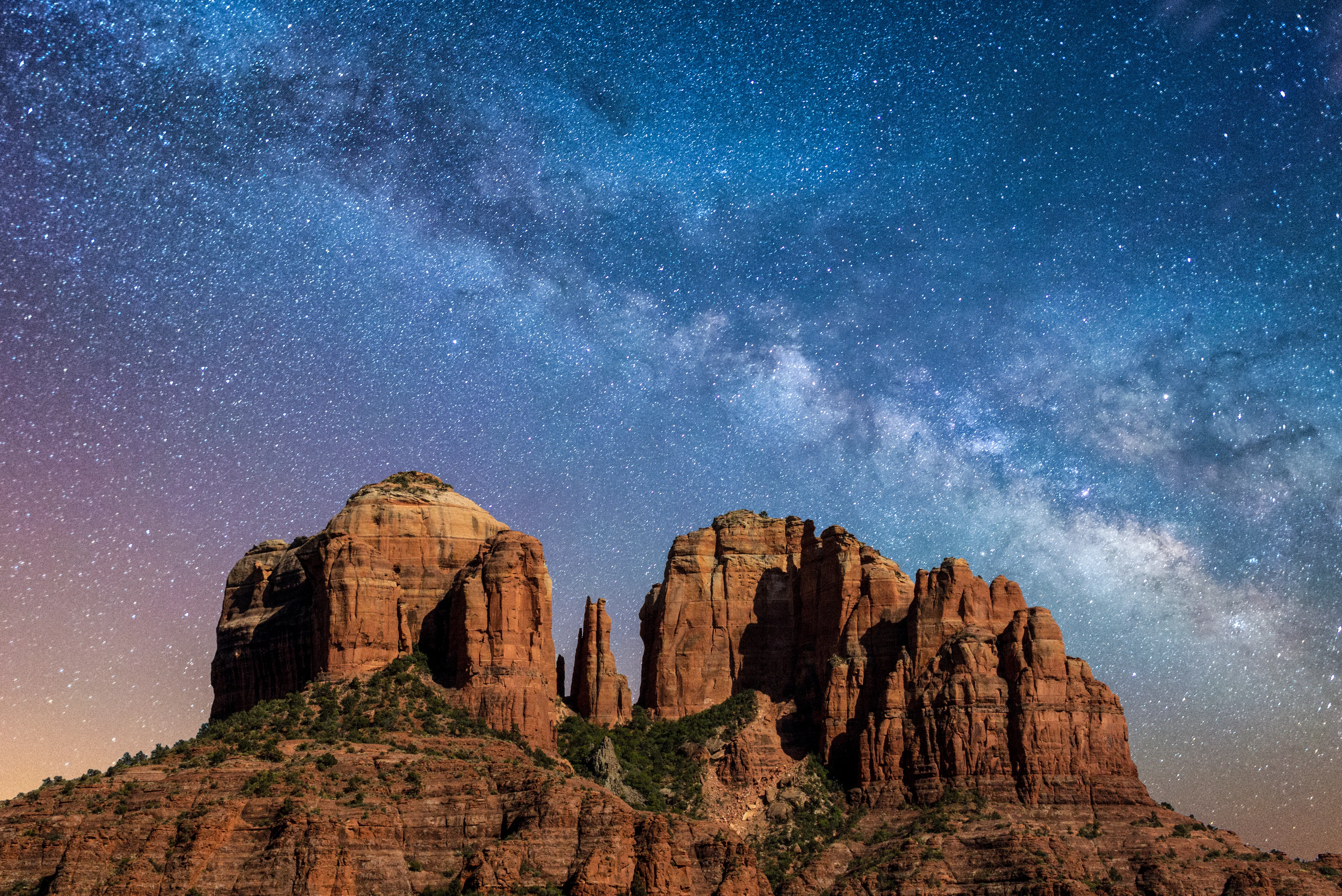 Image of Cathedral Rock in Coconino National Forest, below a stary night sky.
