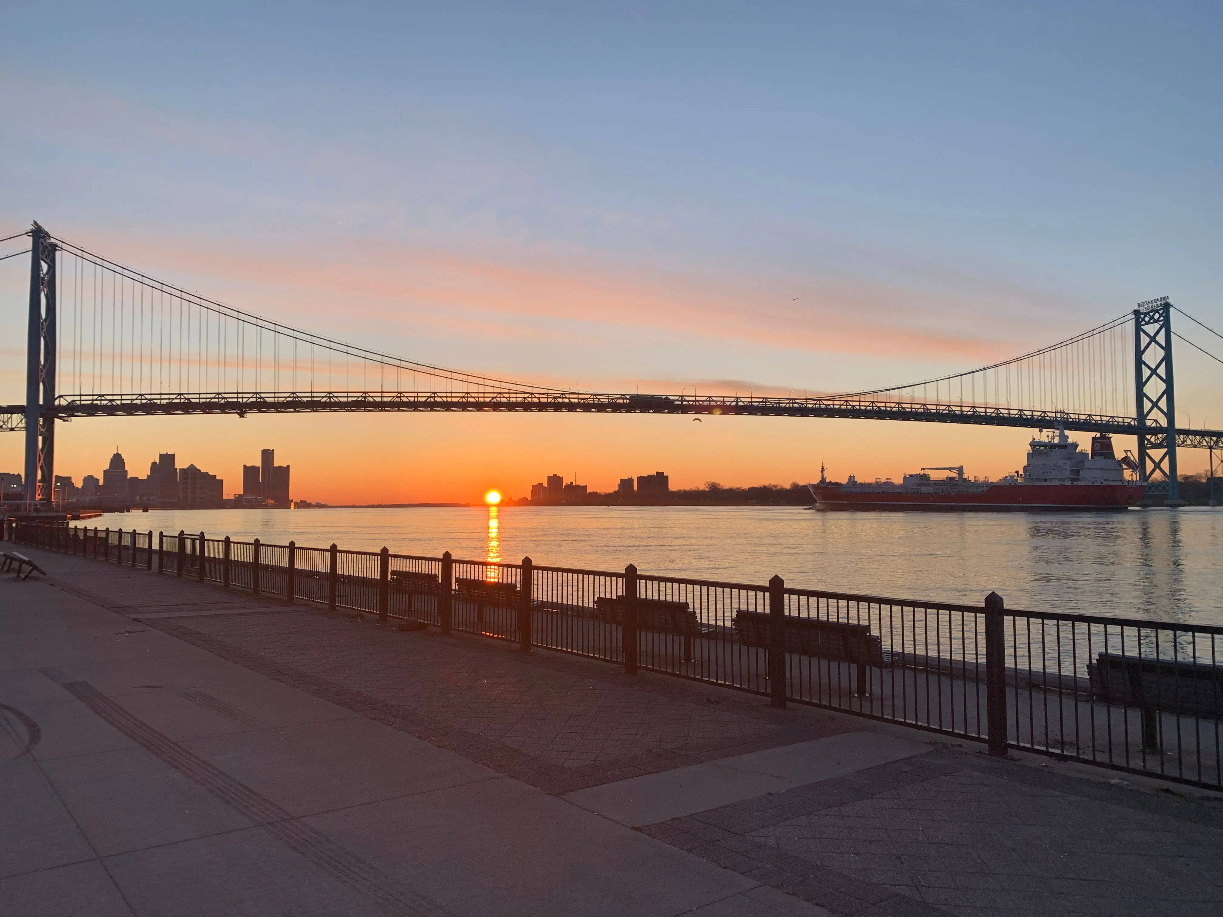 A beautiful view of the sun rising over the Ambassador Bridge in Detroit, Michigan