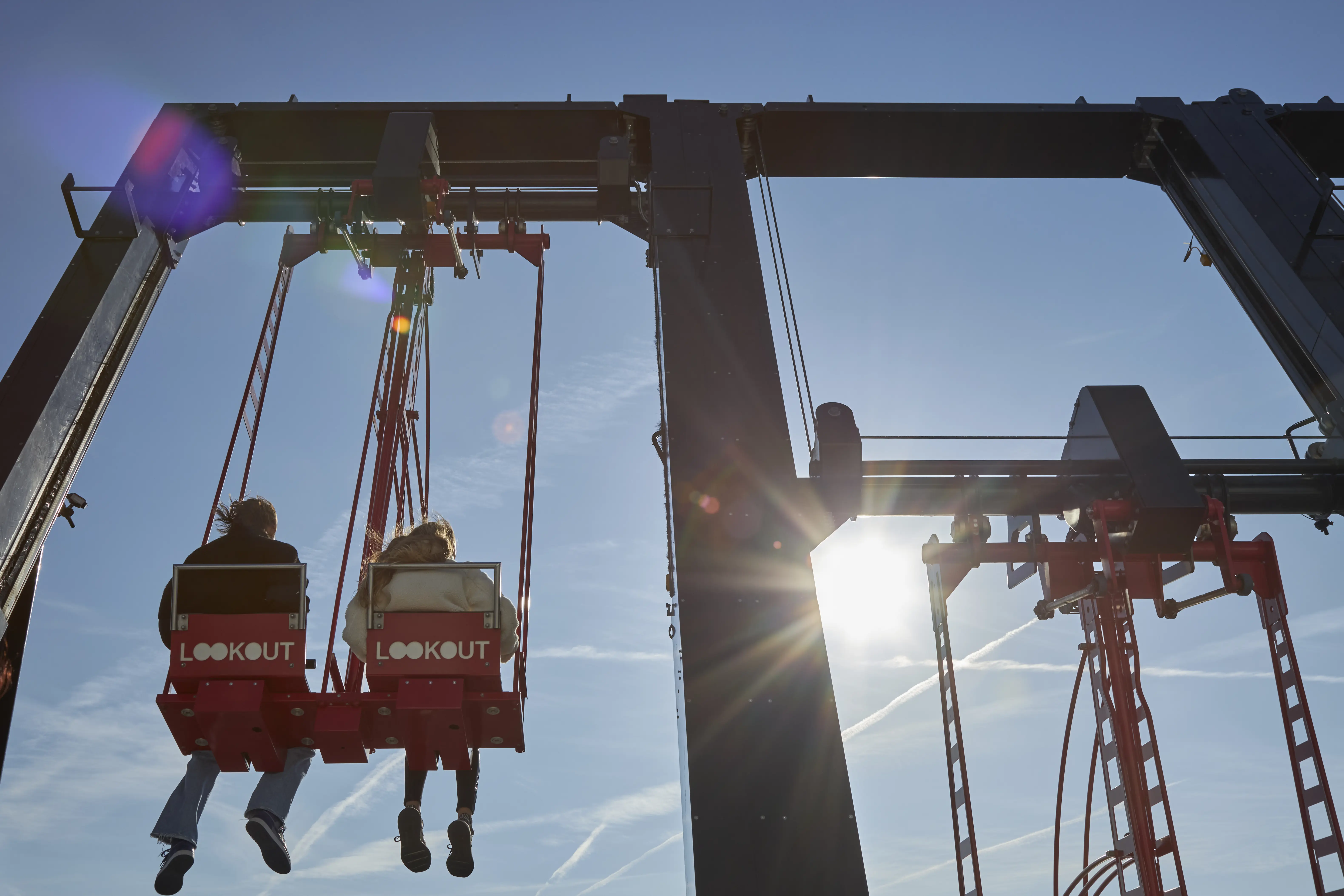 Image of two people riding the swing at A’dam Lookout, Amsterdam.
