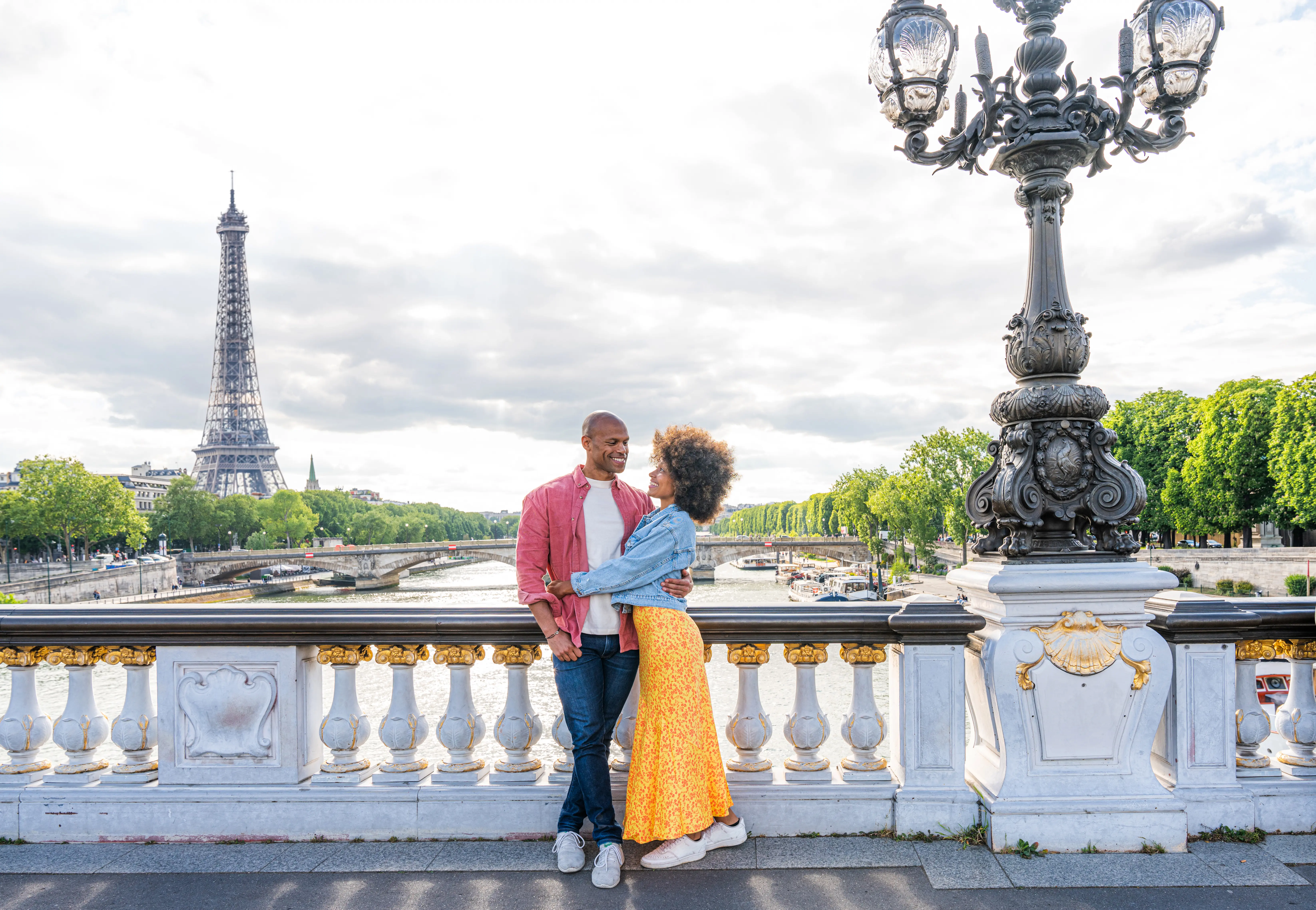 African American tourists with view of river and Eiffel Tower in background