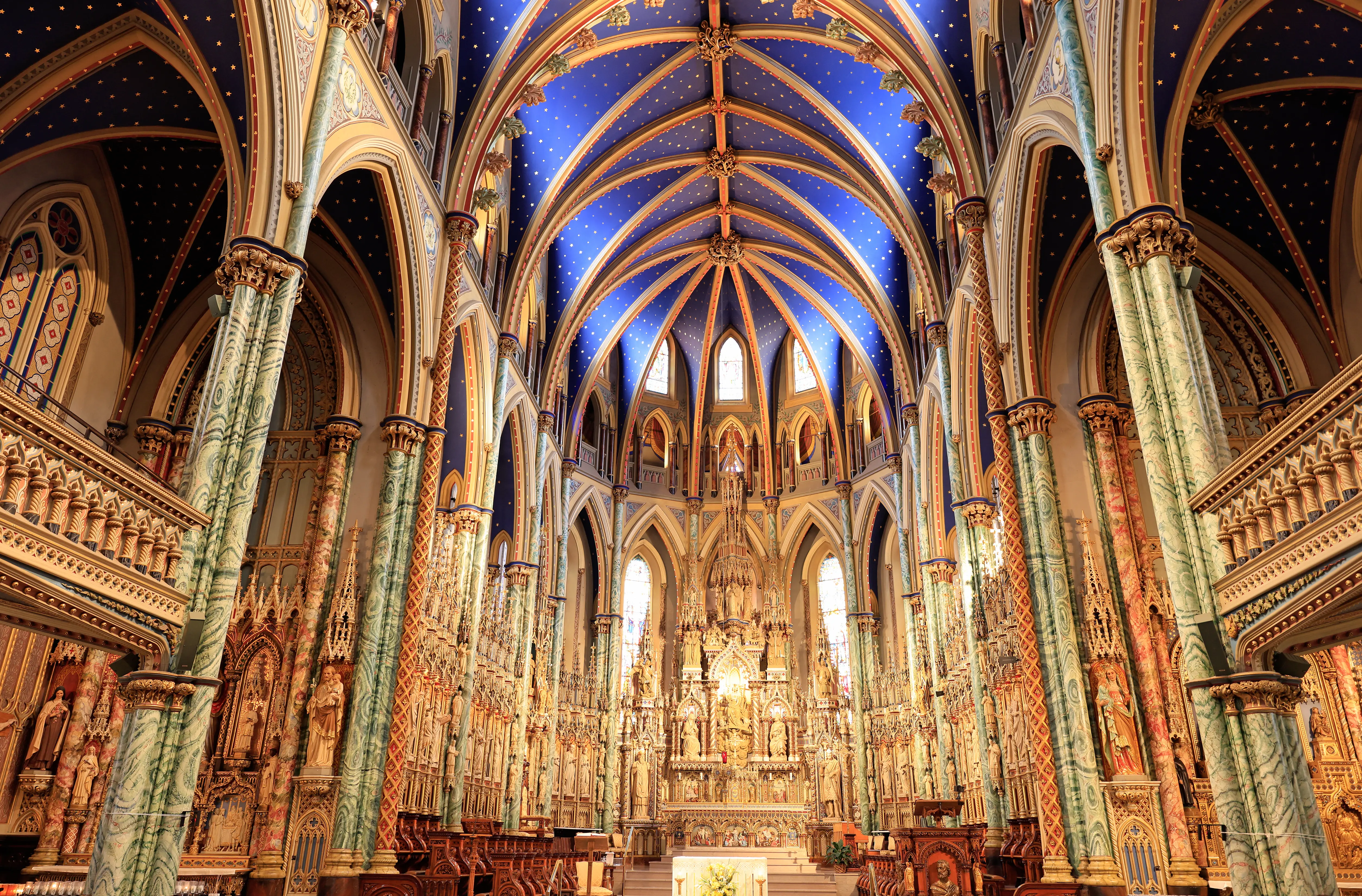 Interior of Notre-Dame Cathedral Basilica featuring arched ceiling, elaborate decoration, and stunning stained glass windows, Ottawa, Ontario, Canada