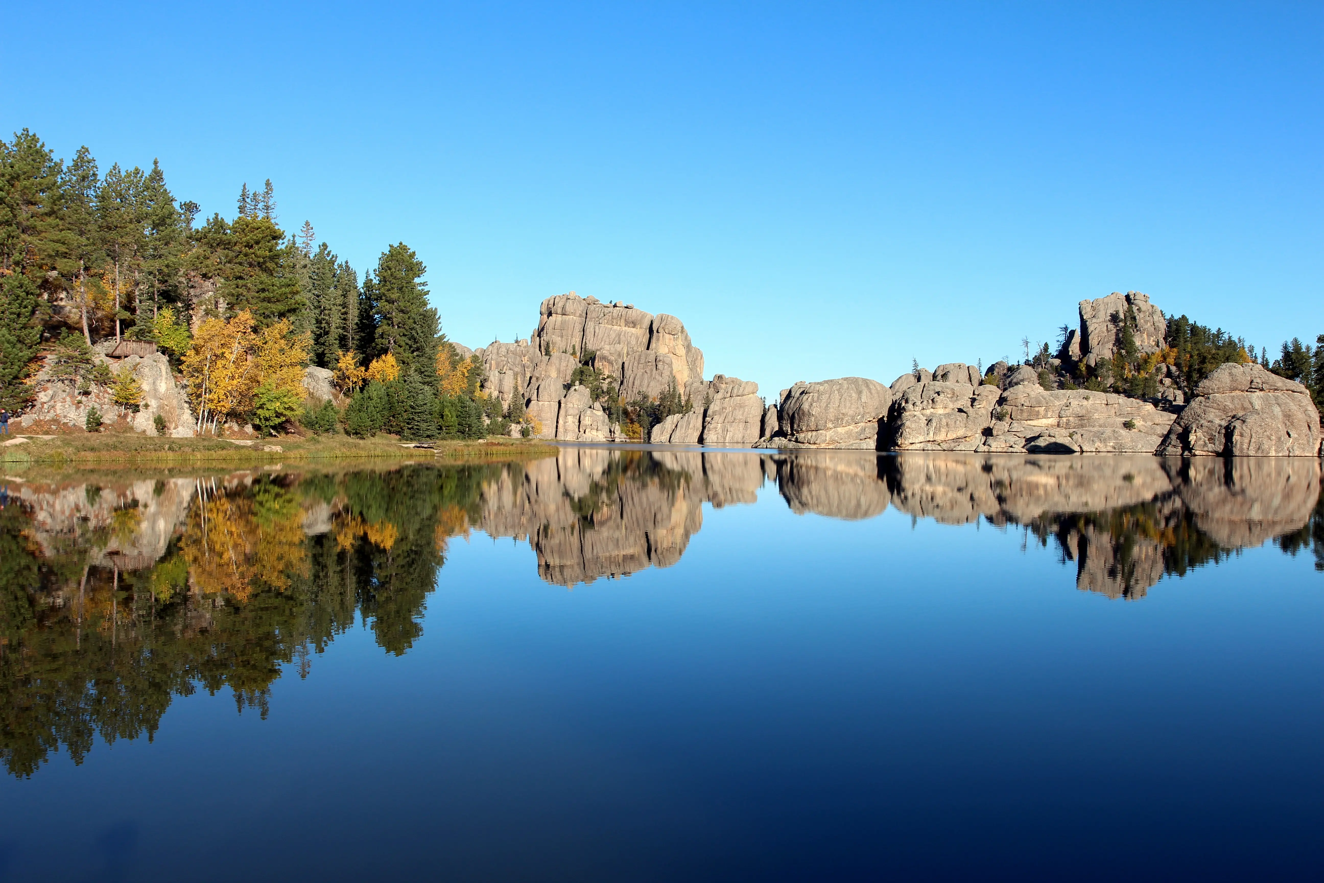 Image of the water and surrounding boulder landscape of Sylvan Lake State Park, Colorado.