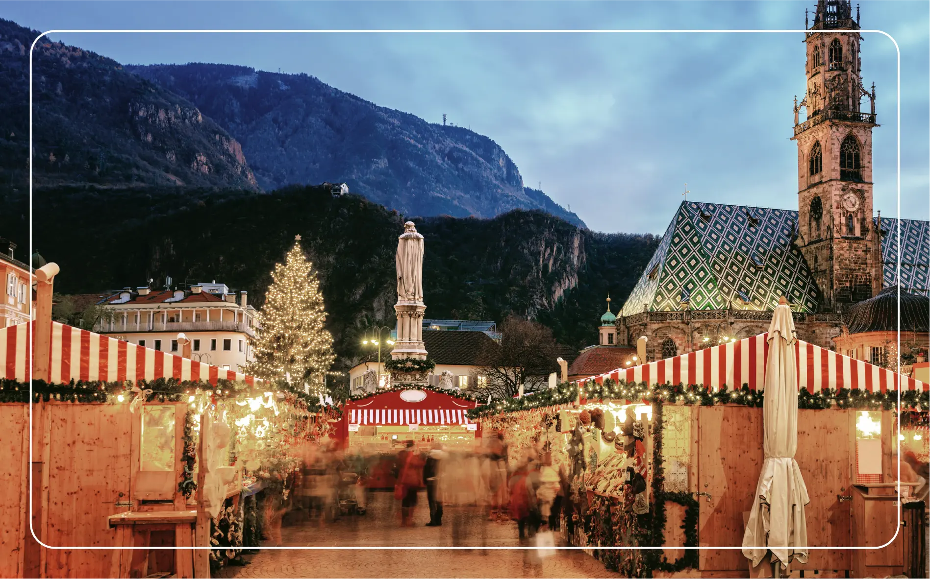 An Italian Christmas Market with mountains in the background.