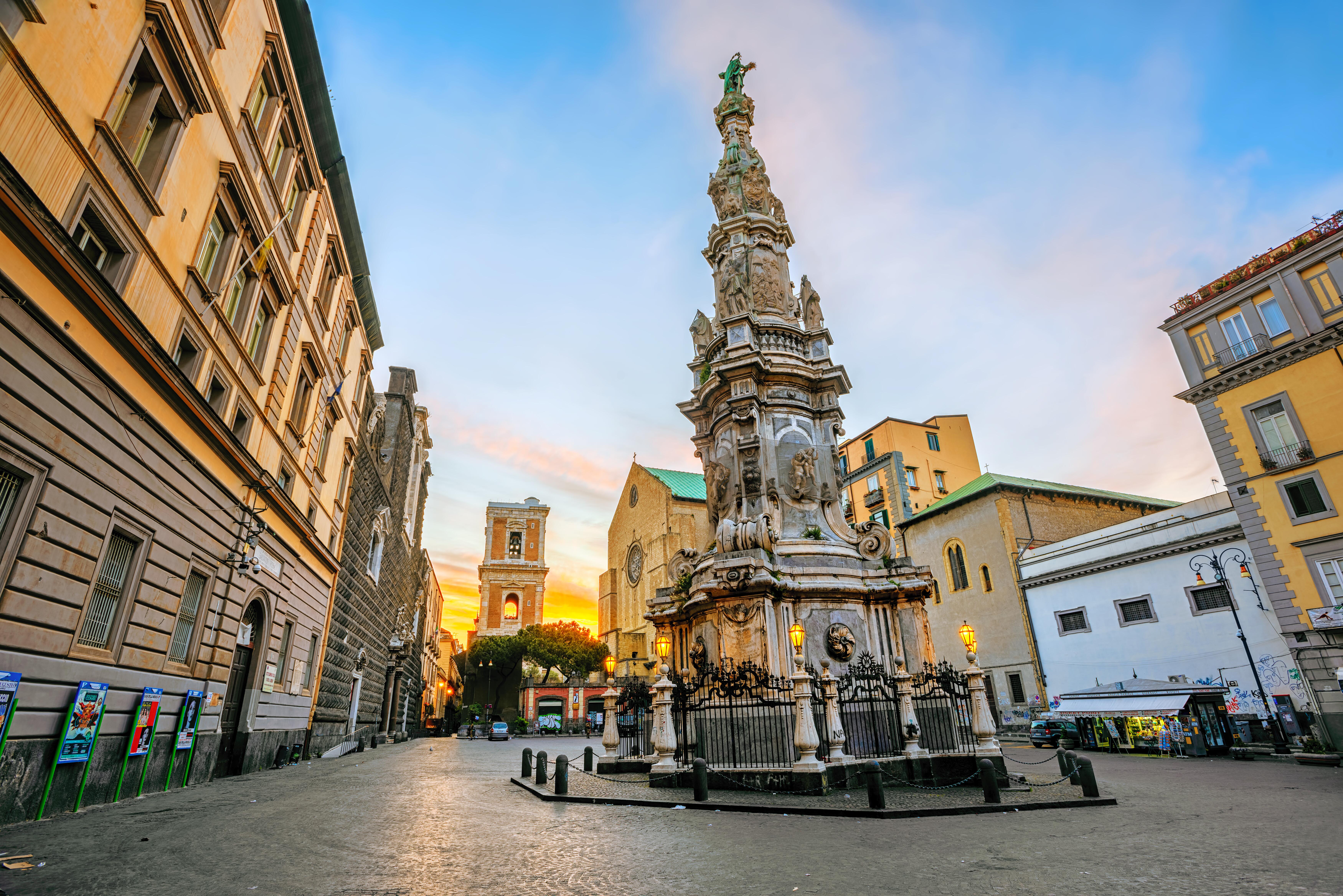 Gesu Nuovo square in historical old town center of Naples with Guglia dell'Immacolata obelisk and baroque architecture