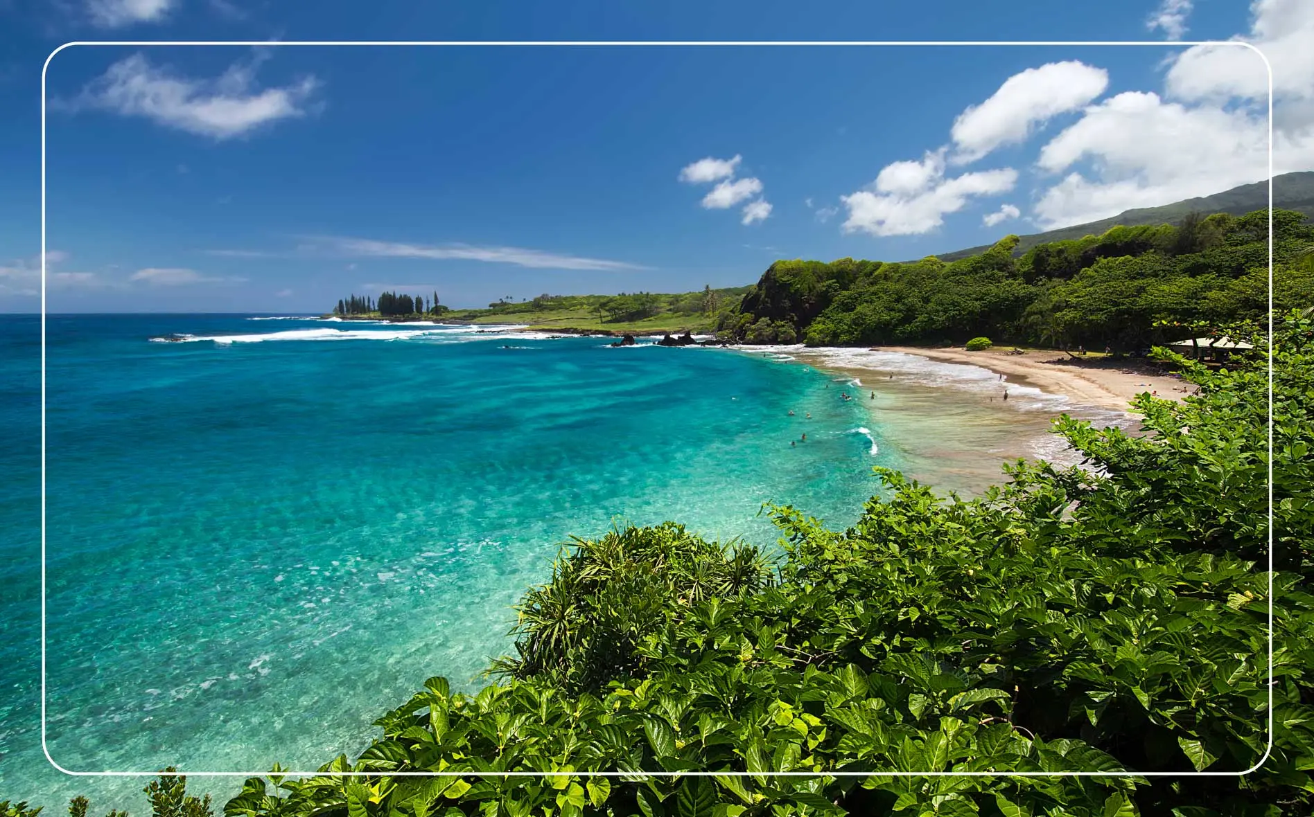 A wide view showing the crescent shape of Hamoa Beach on Maui, Hawaii.