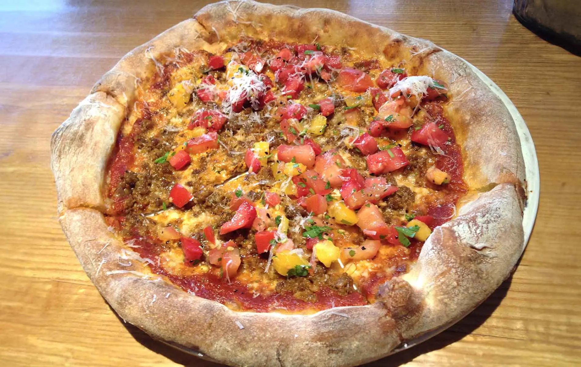A delicious woodfire pizza freshly cooked with vegetables on top