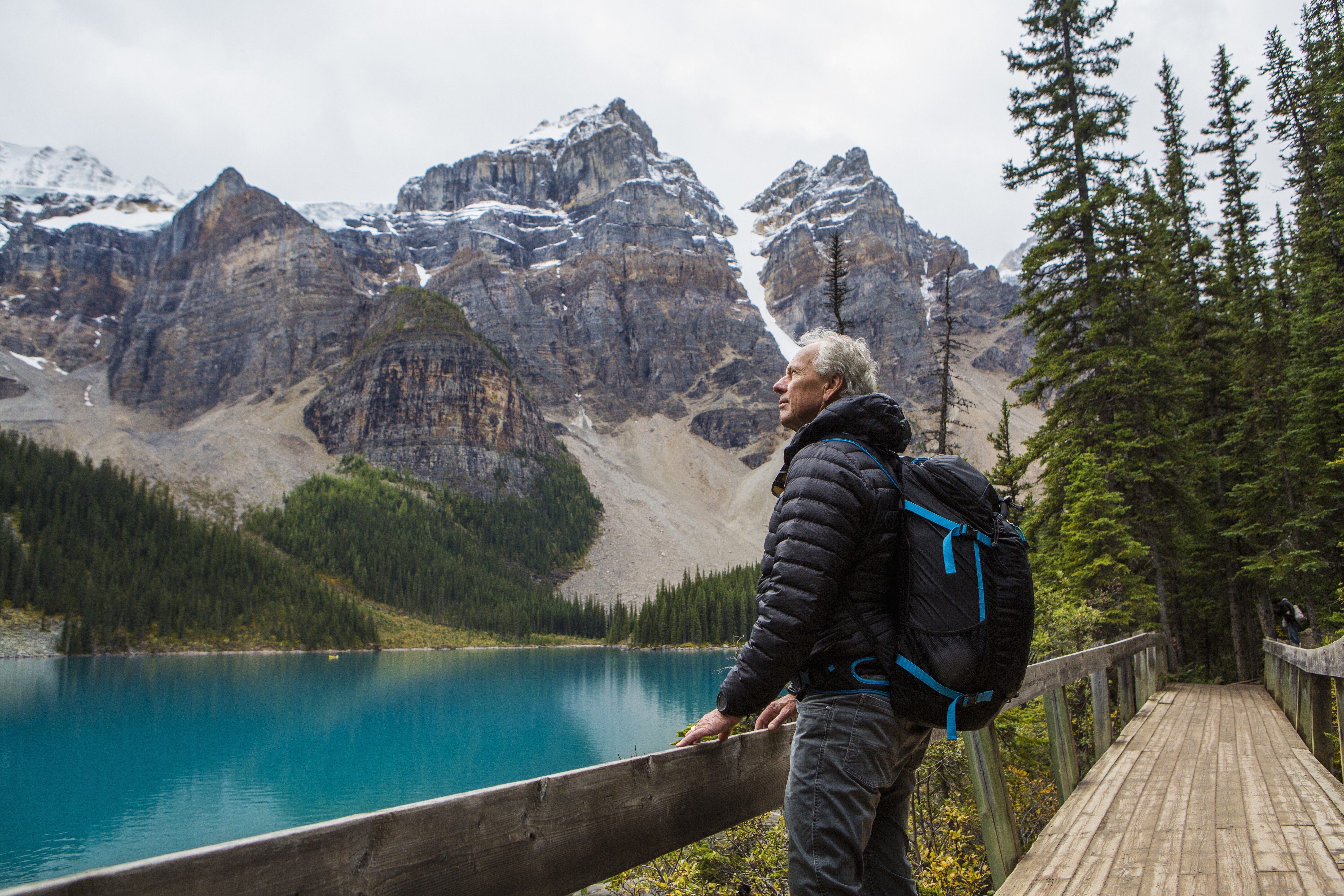 Image of an older man taking in the scenic view of a wilderness park.