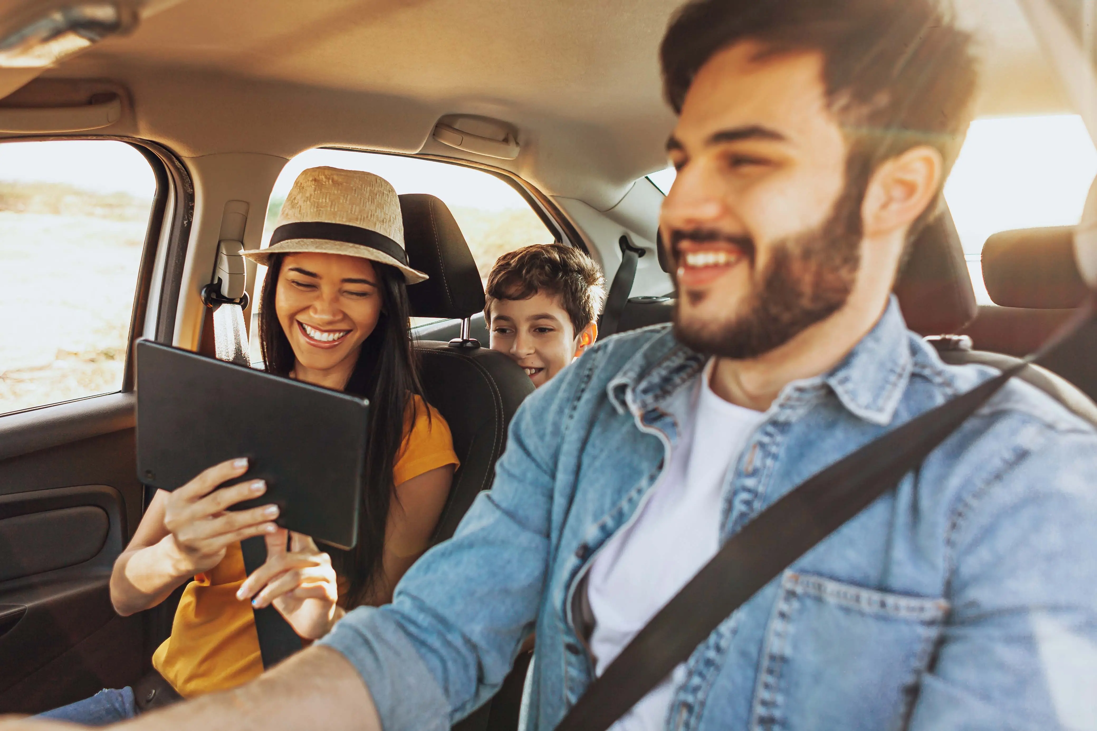 Family in car using a tablet