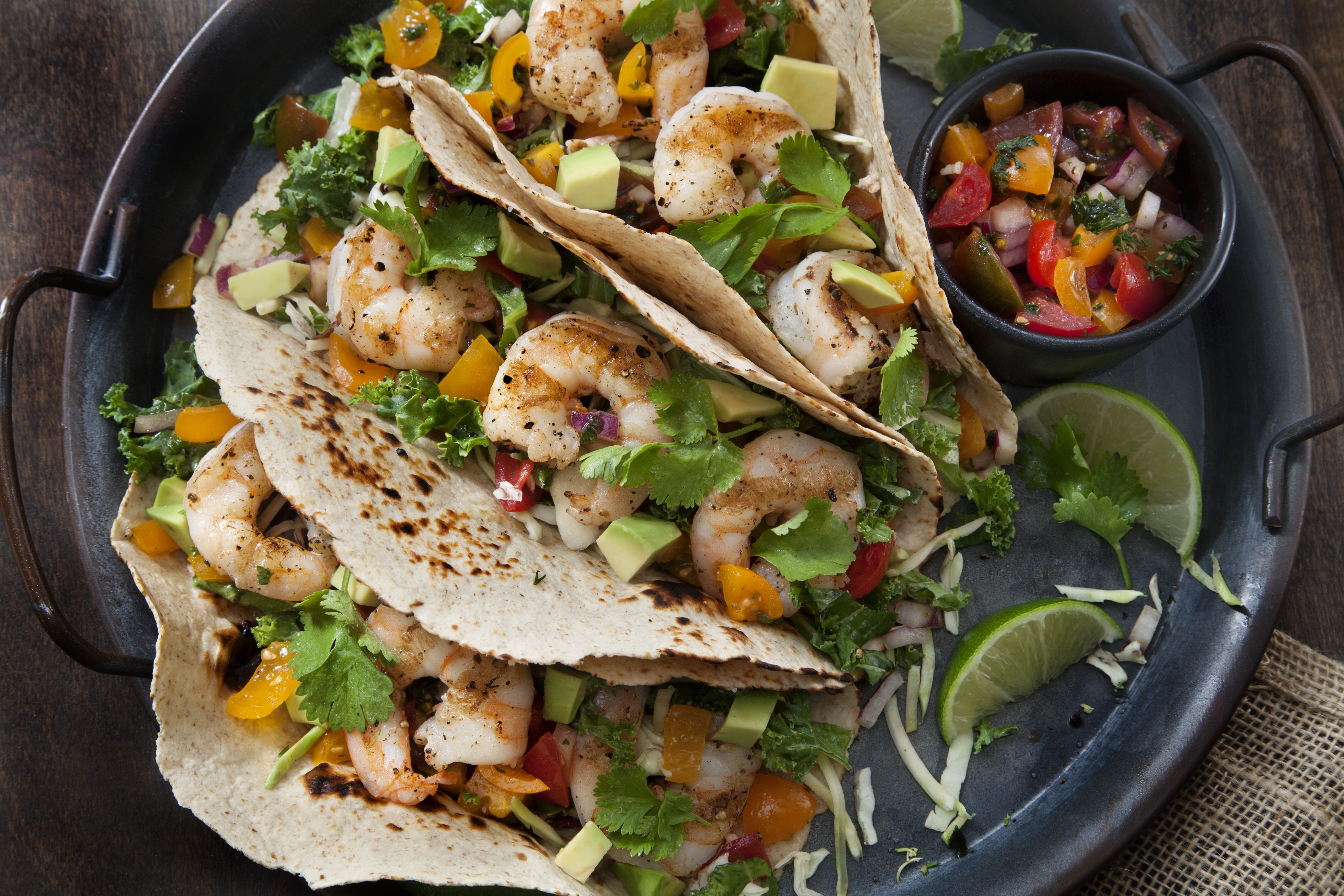 Closeup image of a plate of shrimp tacos.