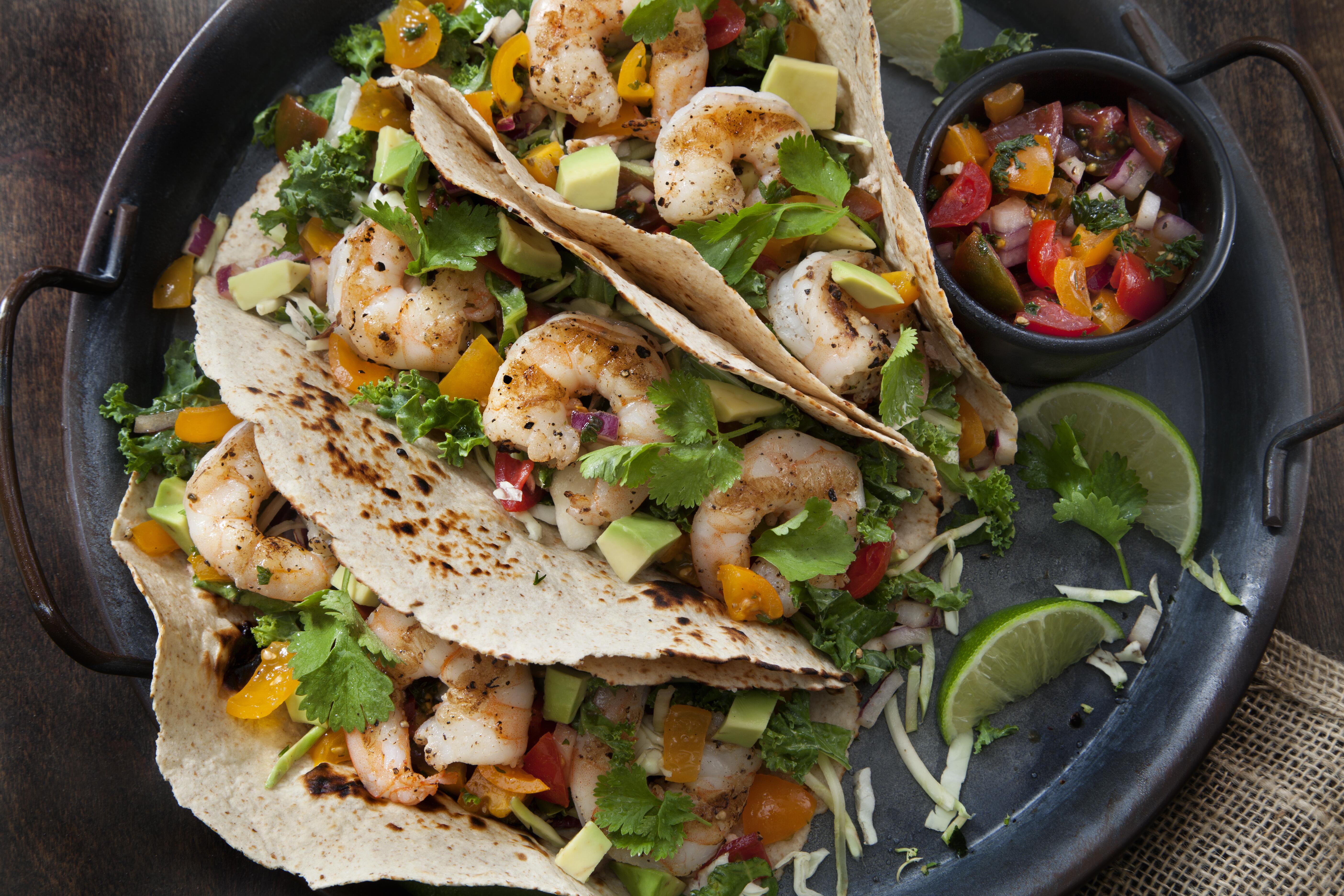 Closeup image of a plate of shrimp tacos.