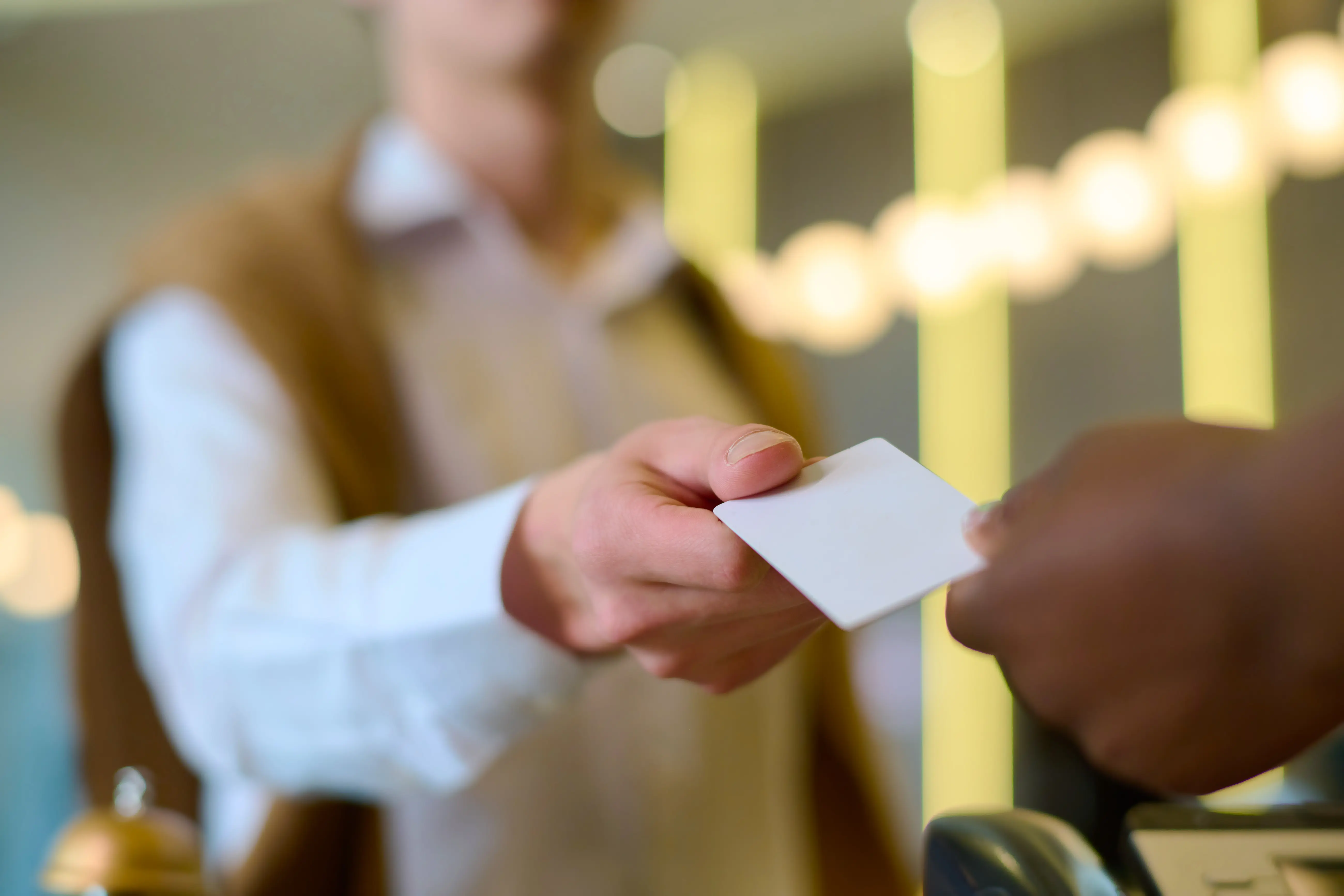 Hotel guest taking keycard at reception