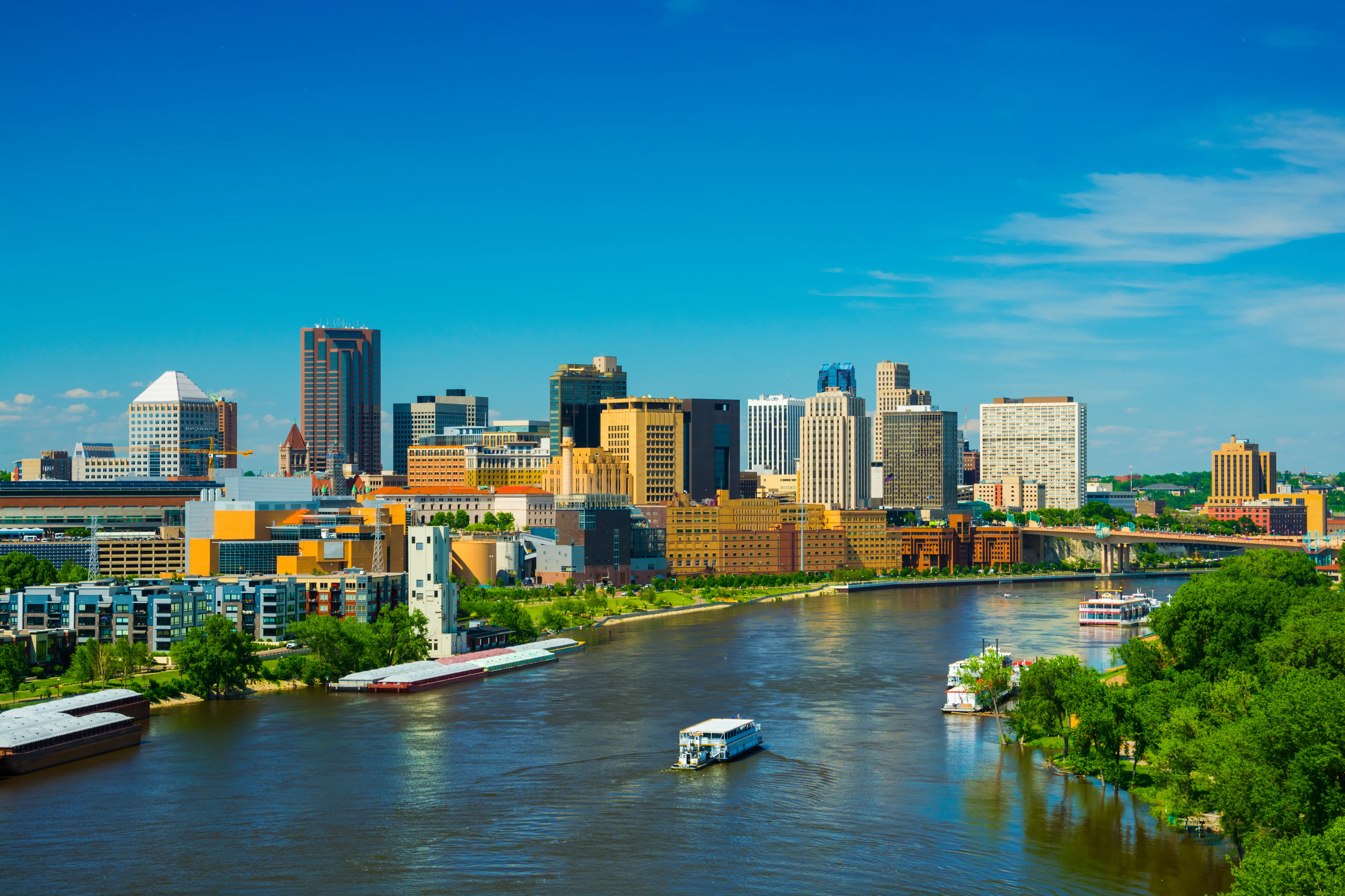 Sunny day view of Saint Paul downtown skyline with the Mississippi River in the foreground