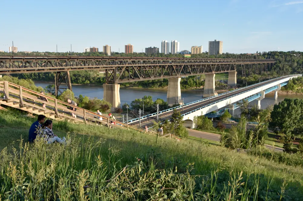 Grassy hills overlooking the river valley and the High Level Bridge at Constable Ezio Faraone Park in Edmonton, Alberta.