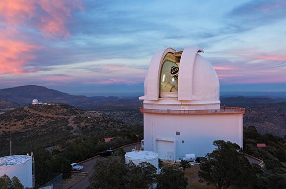 large telescope in white building at McDonald Observatory