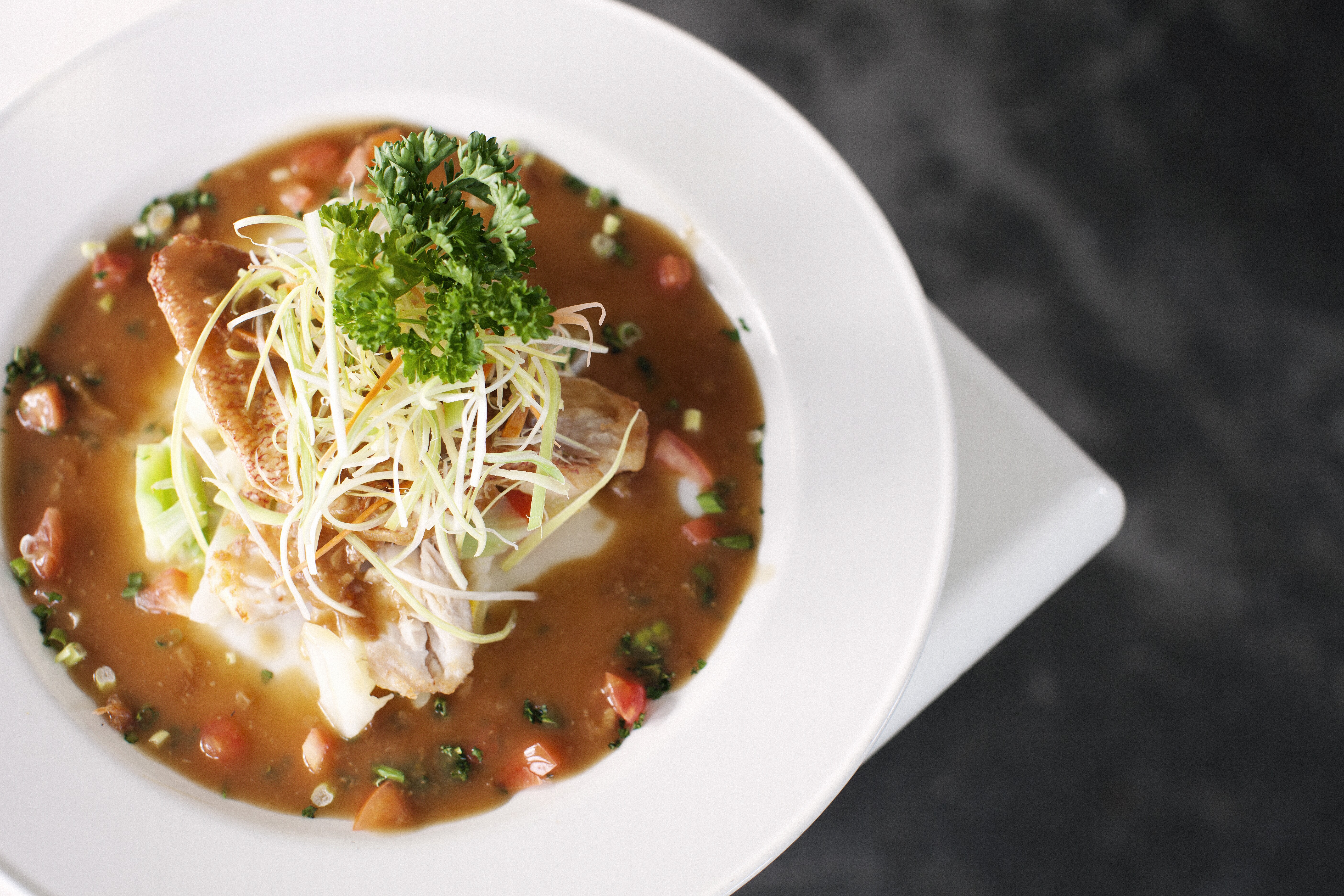 Closeup image of a bowl of seafood gumbo.