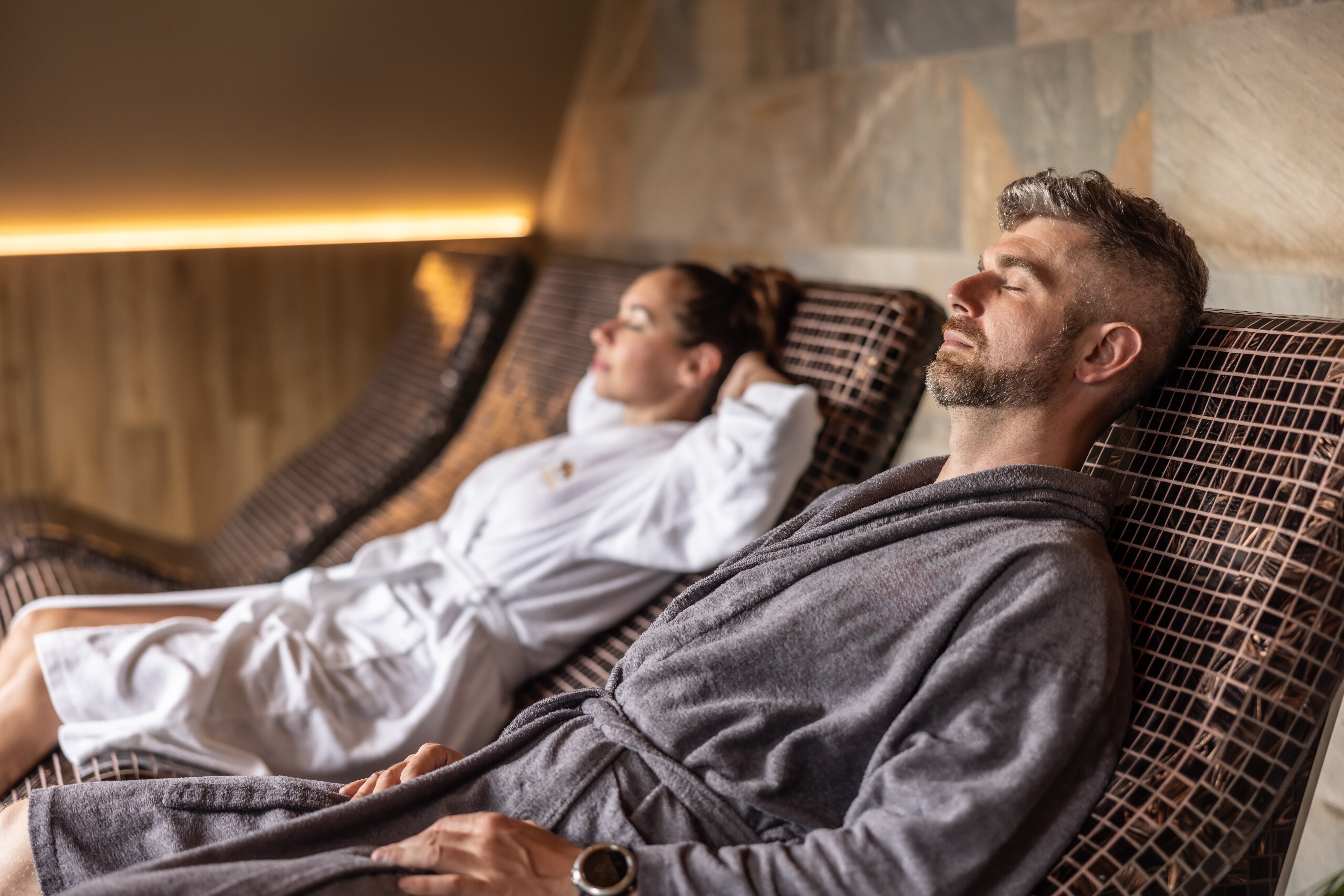 Image of a couple relaxing side by side in a spa.
