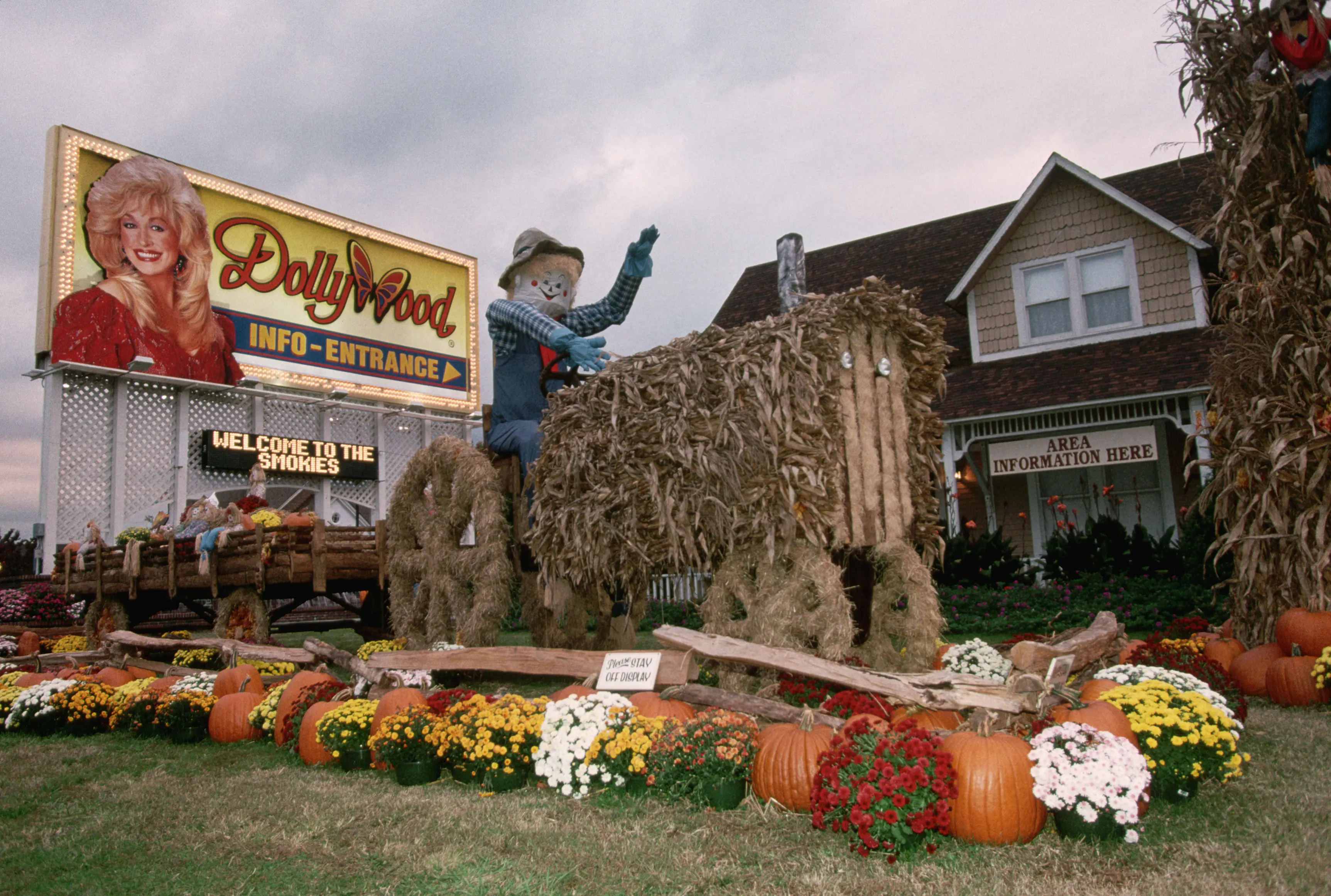 Image of the front entryway and sign for Dollywood, with fall decorations on display.