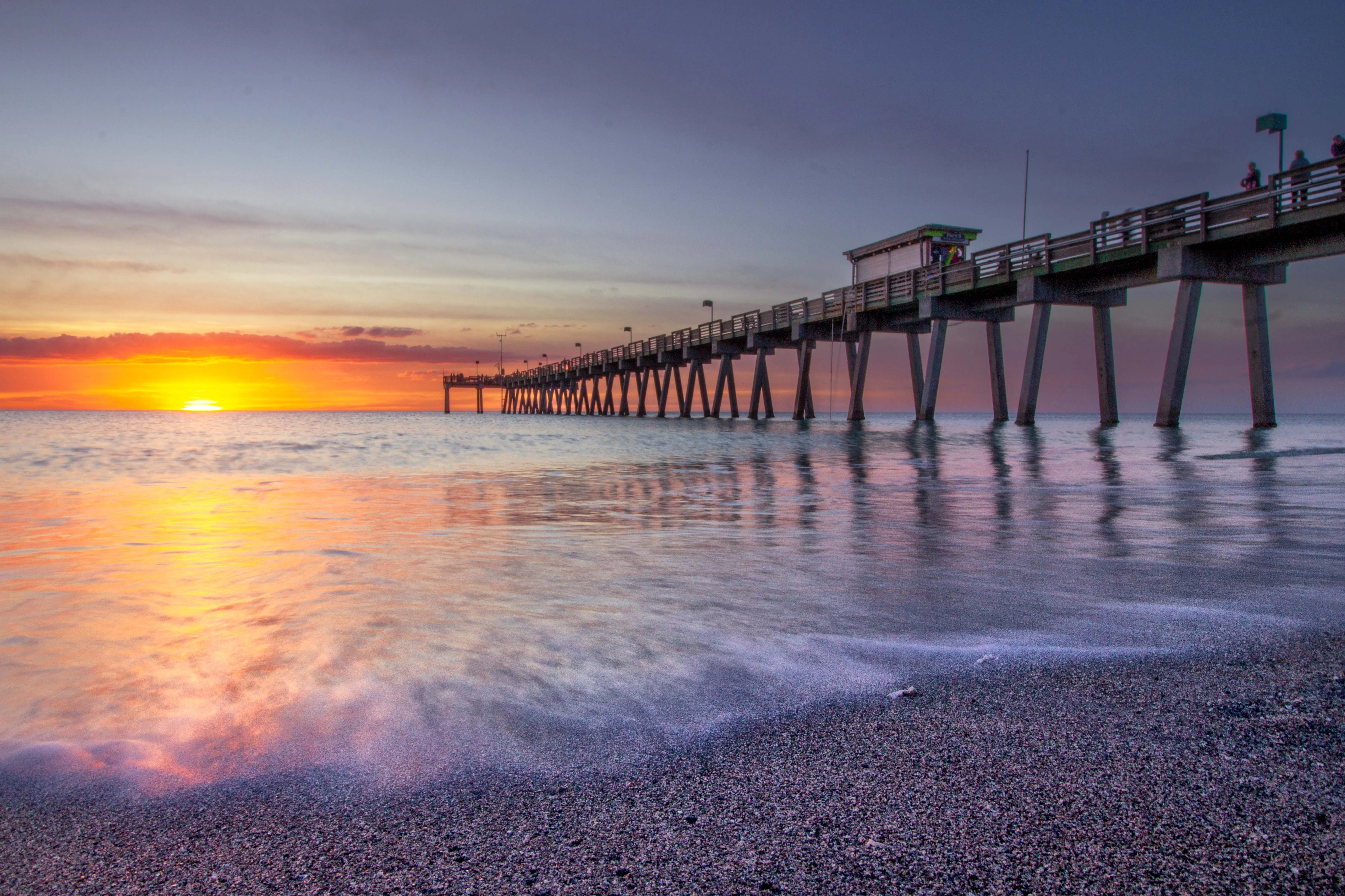 Venice Beach Pier at sunset with purple and orange hues