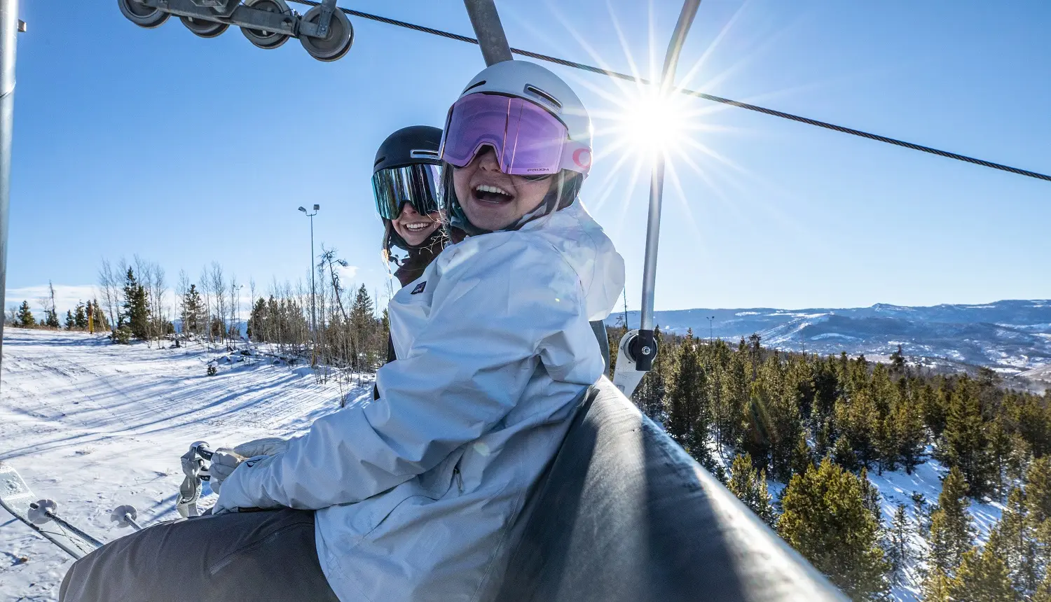 Two girls on a ski lift in Colorado