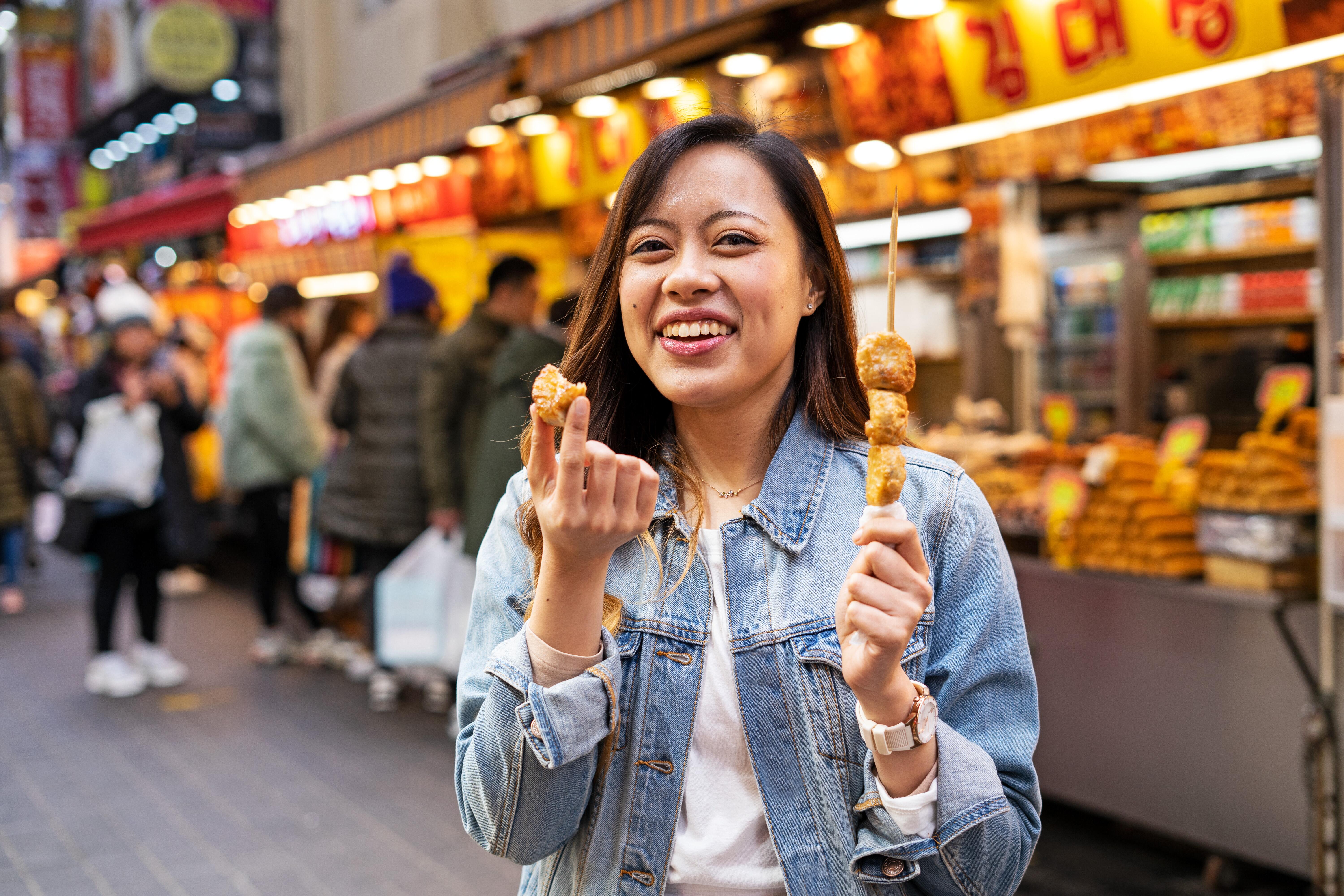 Photo of woman eating street food Seoul