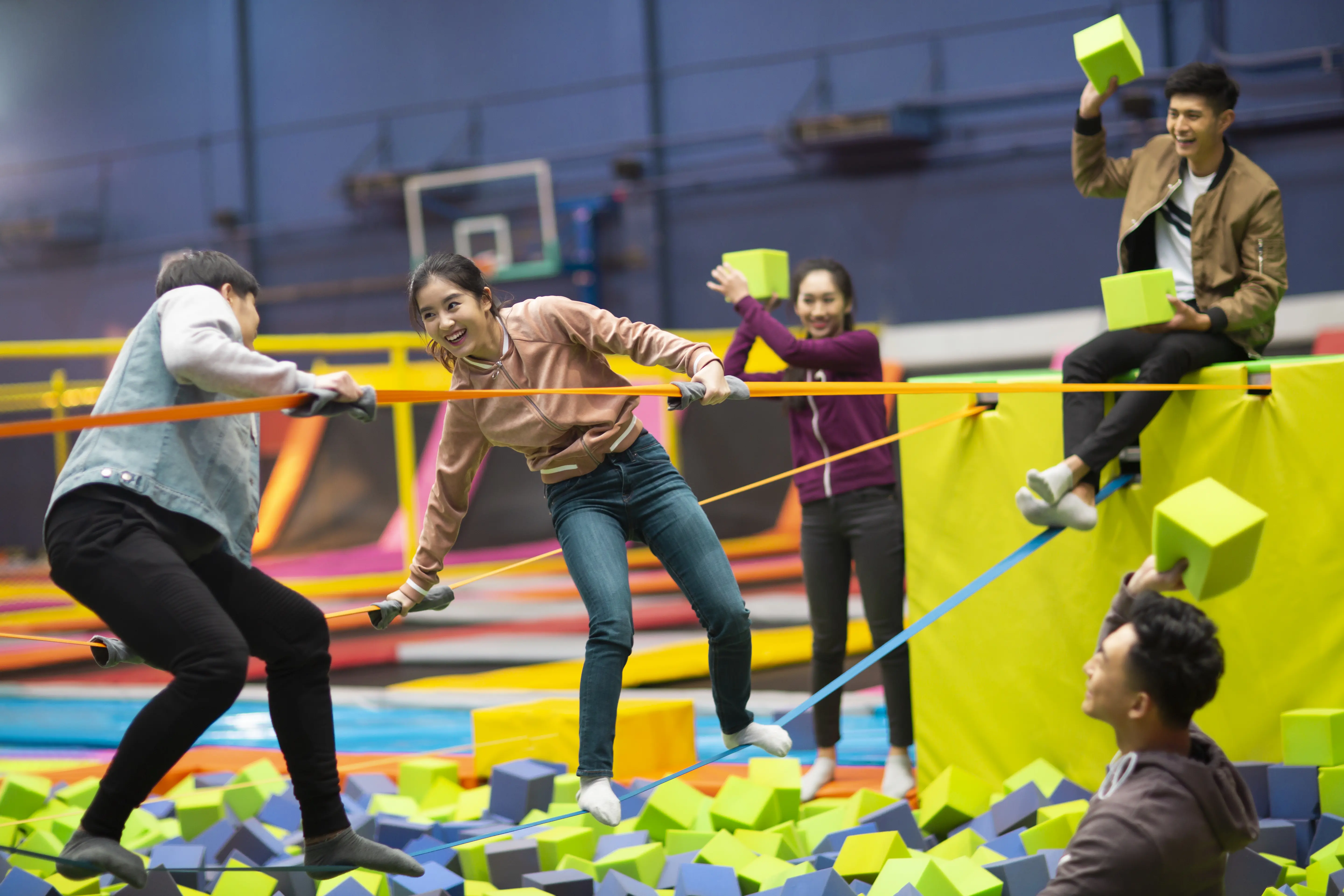 Image of a group of playing in a foam block pit at an indoor adventure park.