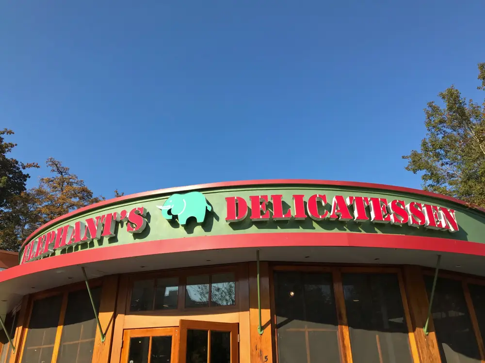 Exterior sign and entrance to Elephants Delicatessen in Portland, Oregon.