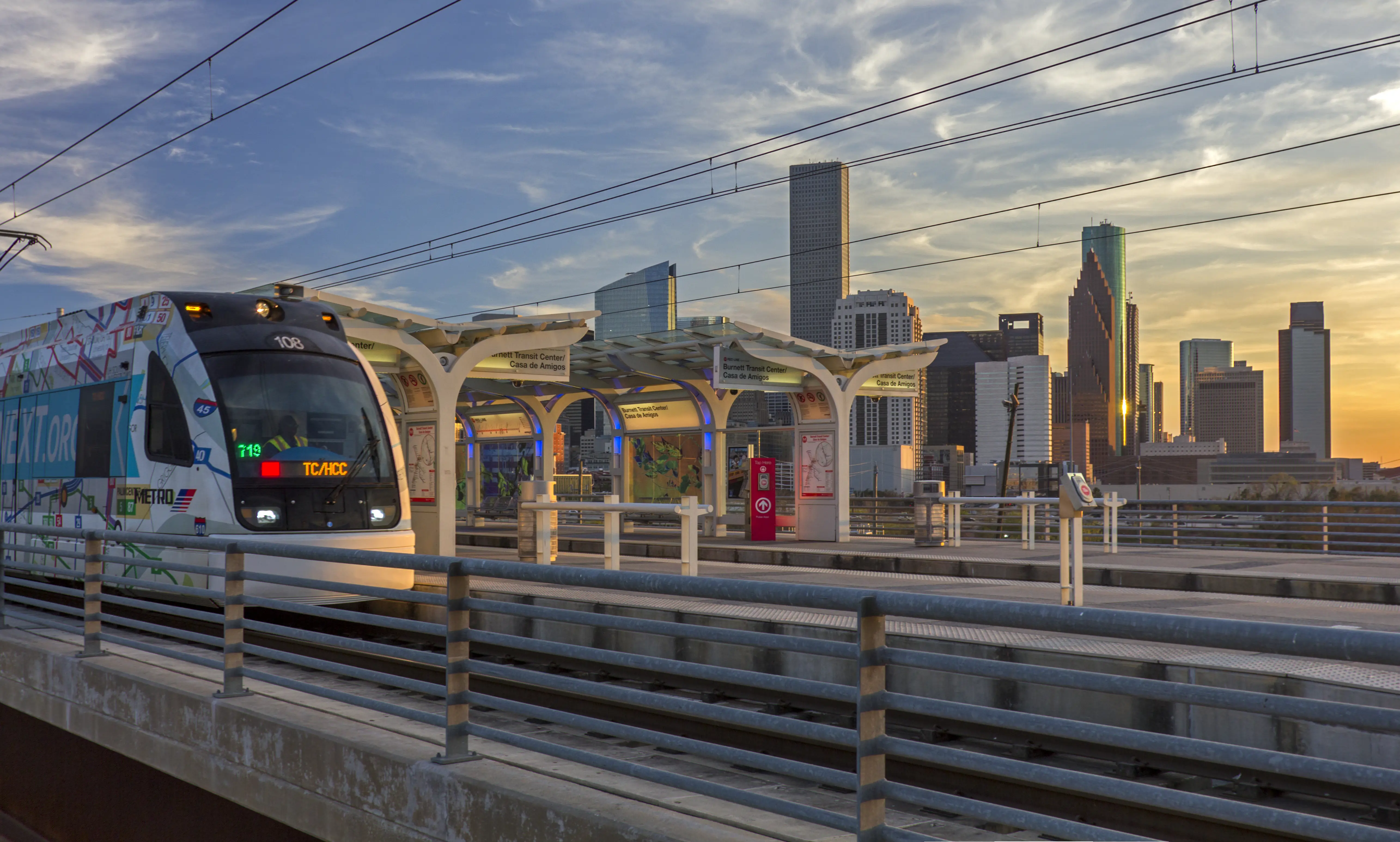 Image of the elevated METRORail train with Houston in the background.