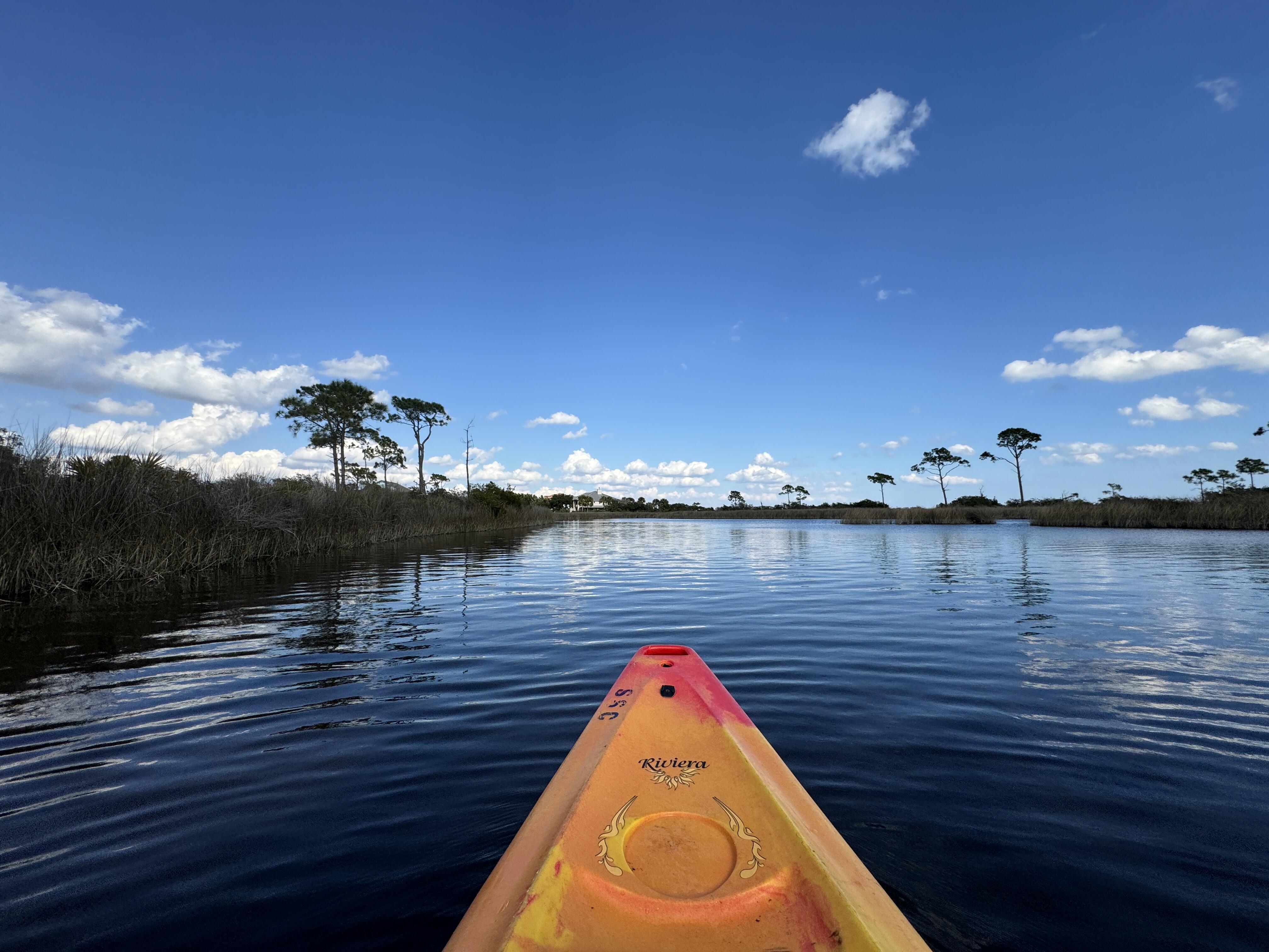Image of a canoe paddling through the water in Pensacola, Florida.