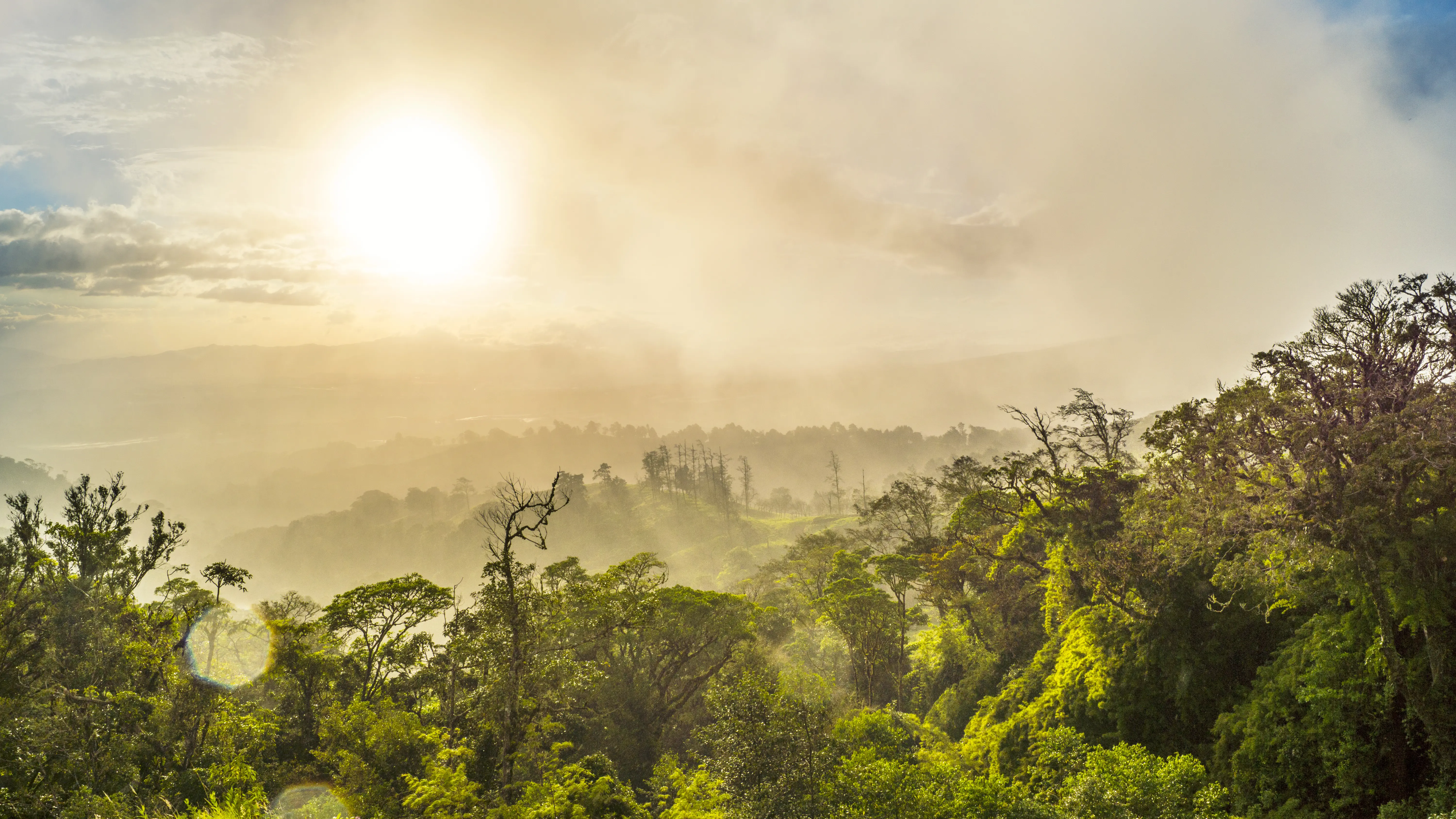 Majestic mountains landscape under late afternoon sky with sunlight, clouds and dew drops. Poas volcano slopes, Alajuela, Costa Rica.