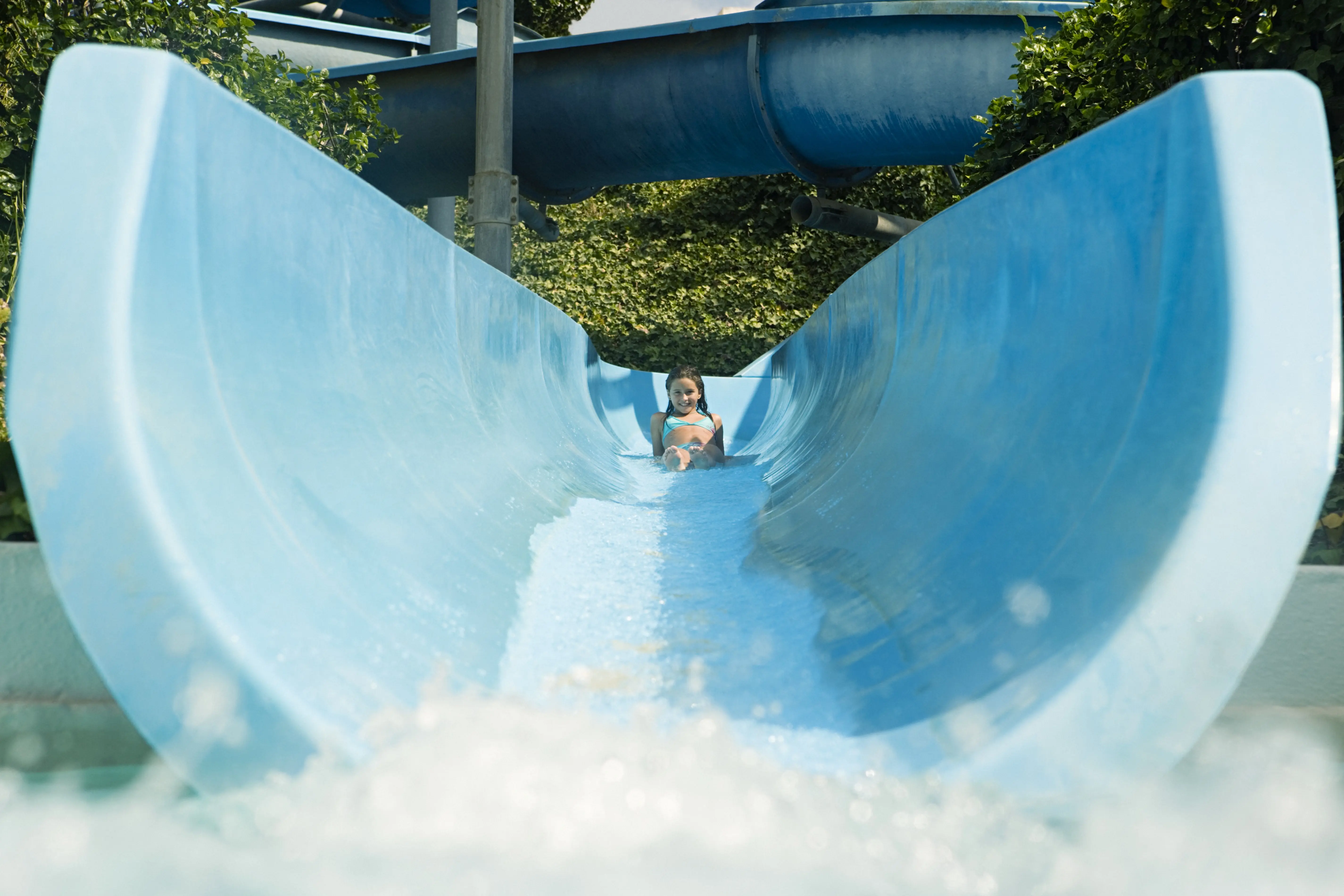 Image of a child on a blue waterslide.