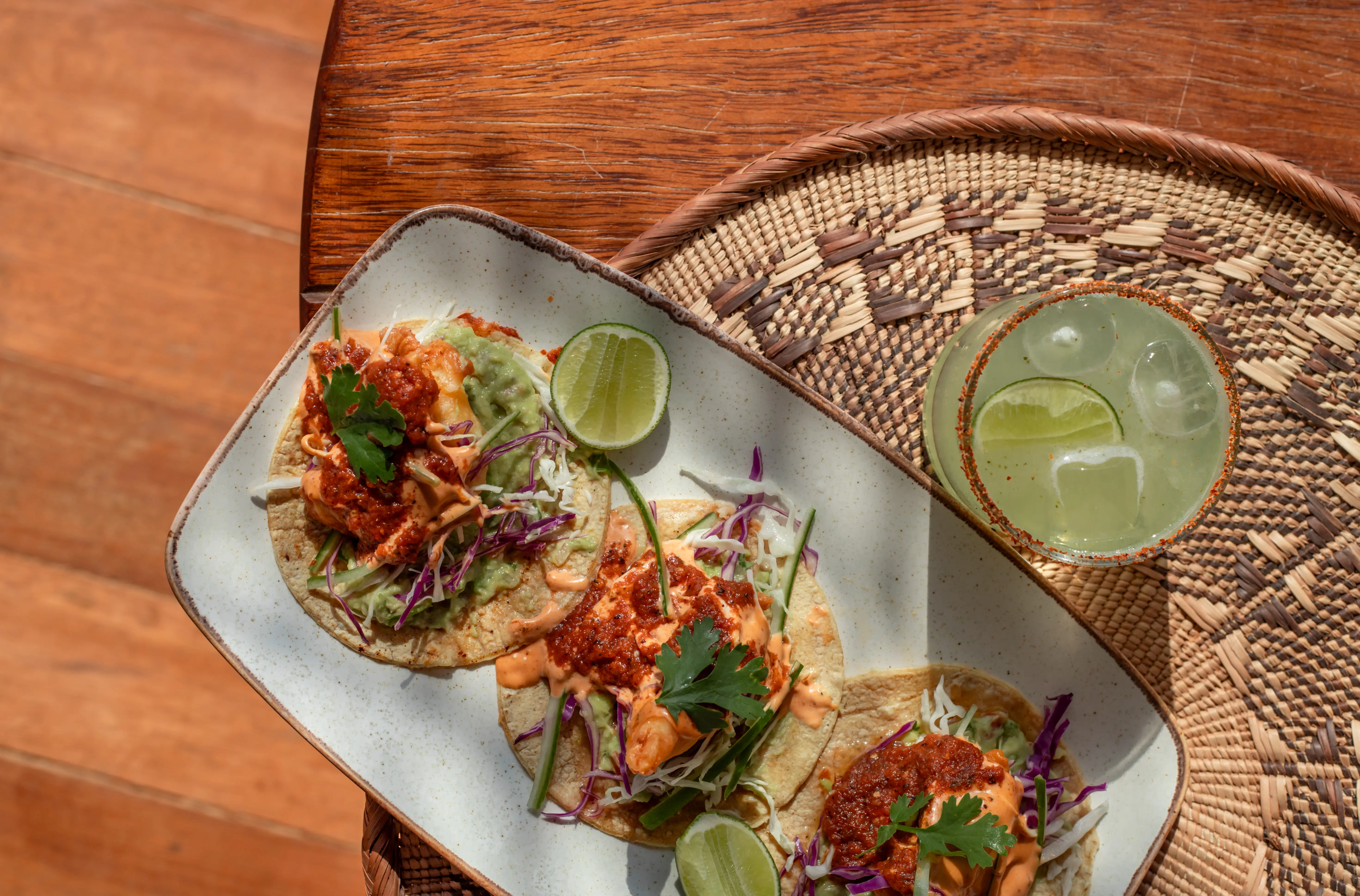 Image of a dish of Mexican Seafood Tacos served alongside a Margarita.