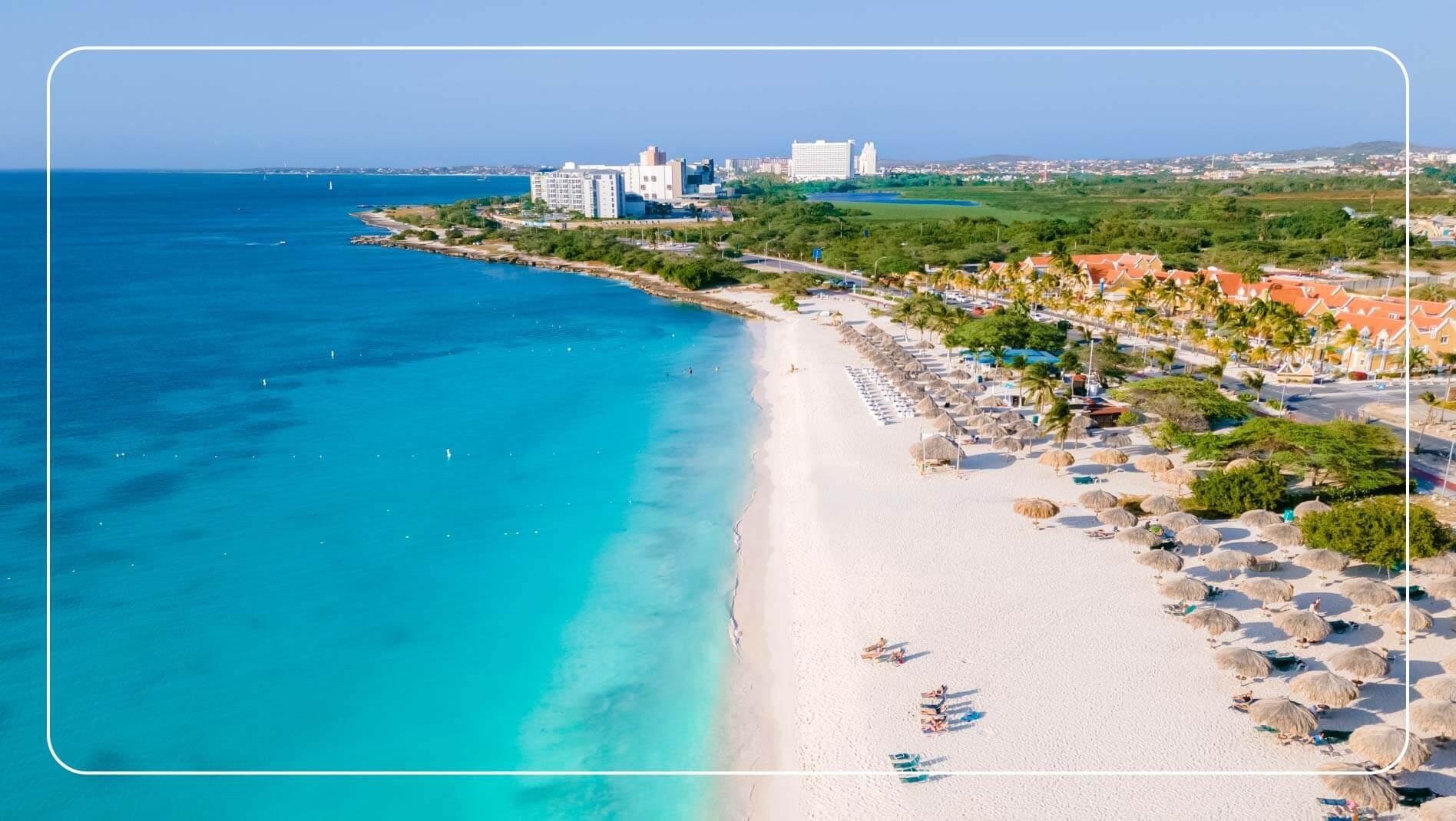 An aerial view of Eagle Beach, Aruba, showing white sand and nearby hotels
