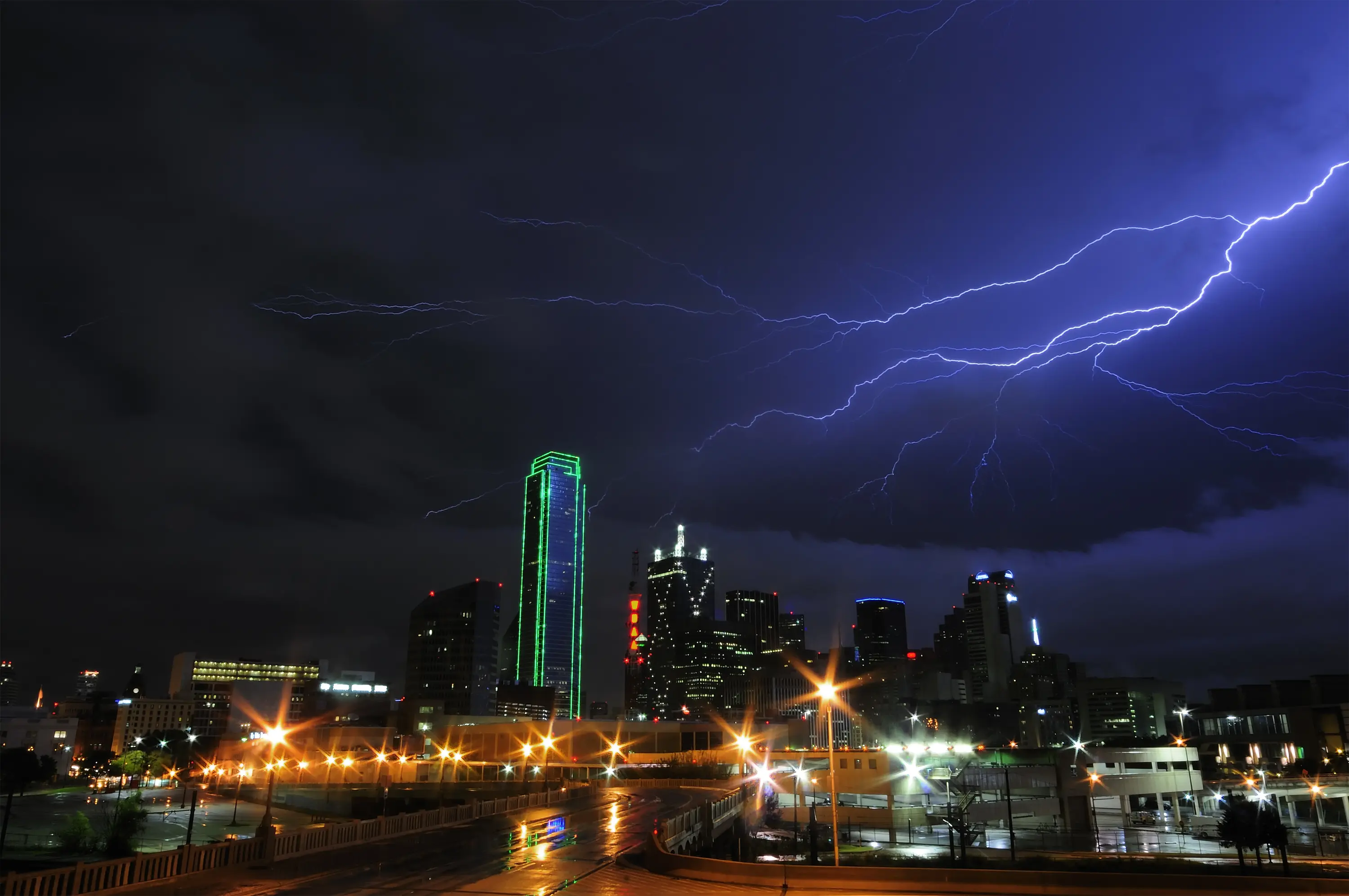 Image of the city of Dallas, Texas, with a large lightning storm overhead.