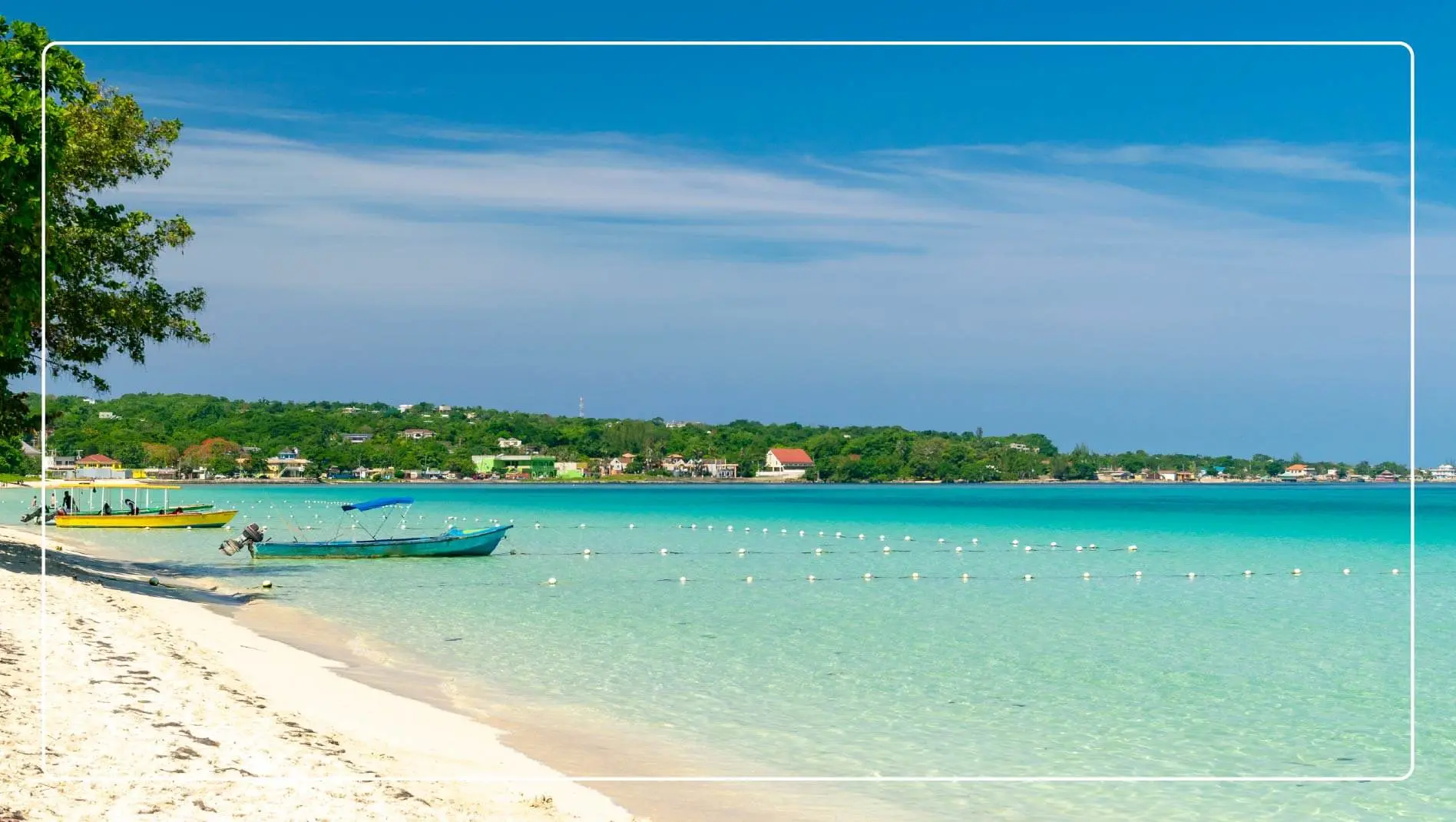Two small boats on a beach in Jamaica.