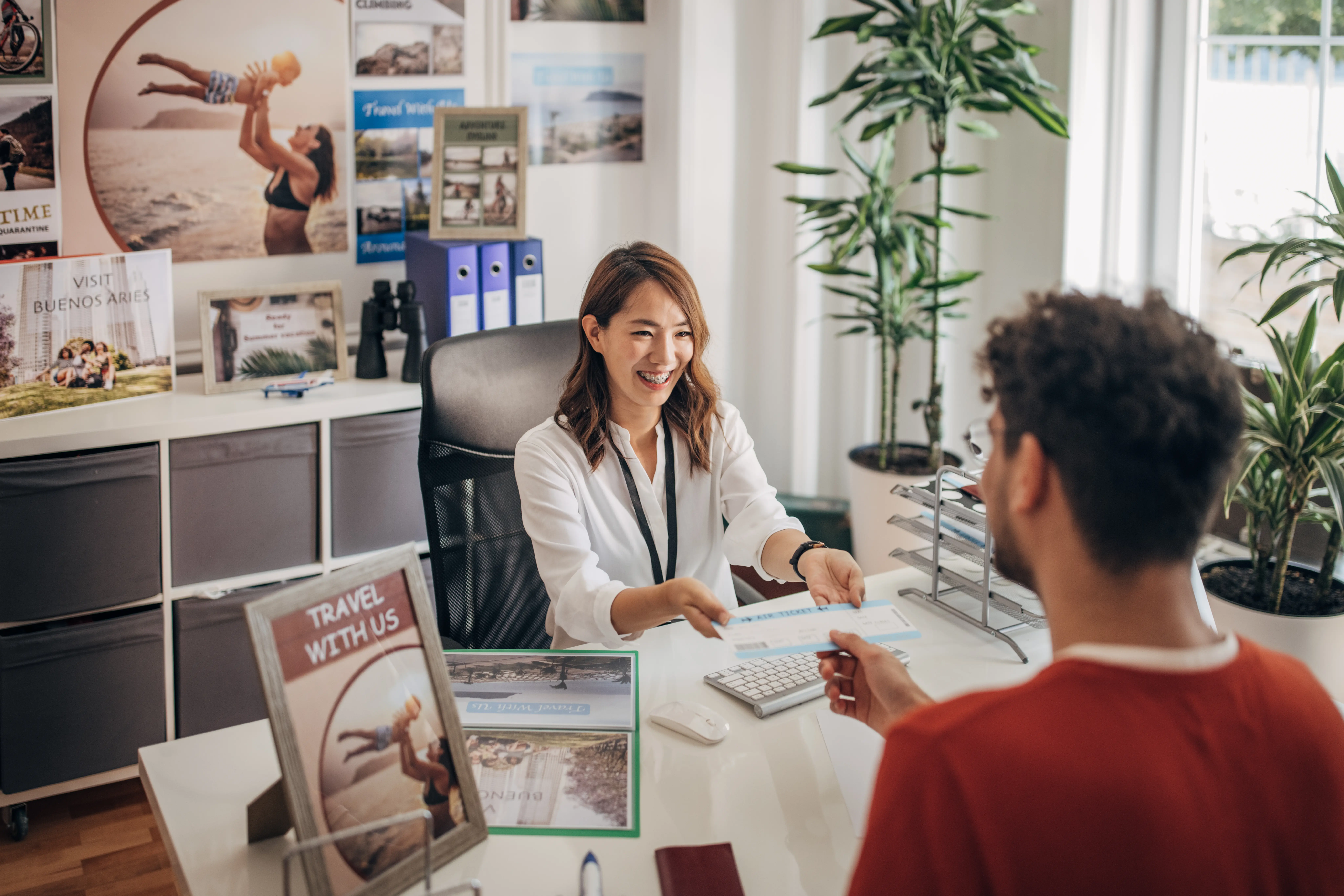 Image of a man meeting with a travel agent to plan a vacation.