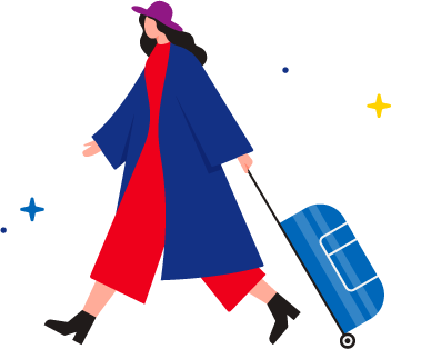 Woman in a red jumpsuit, blue ankle-length jacket, and pink brimmed hat pulling a light blue suitcase.