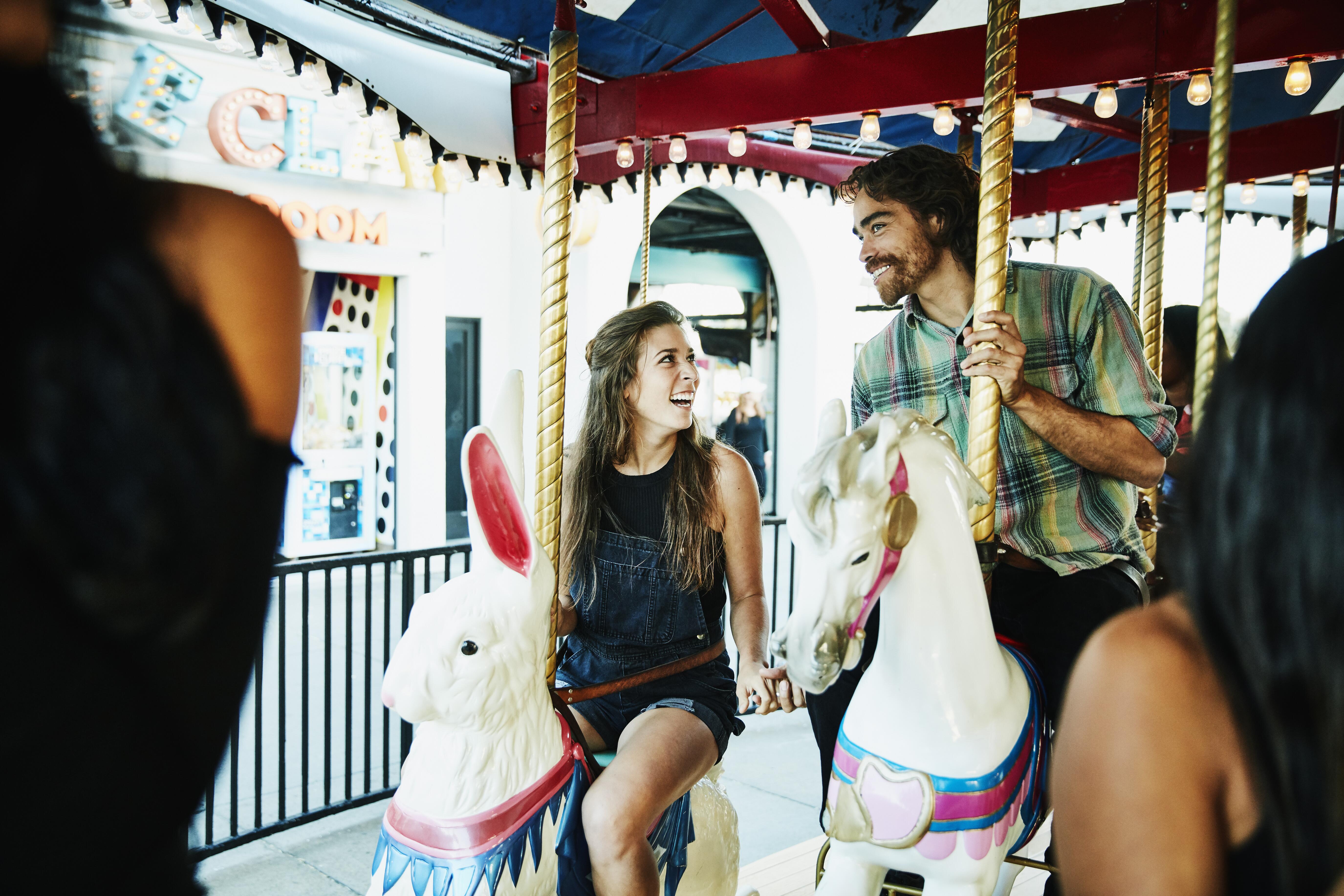 Image of a couple on carousel together.