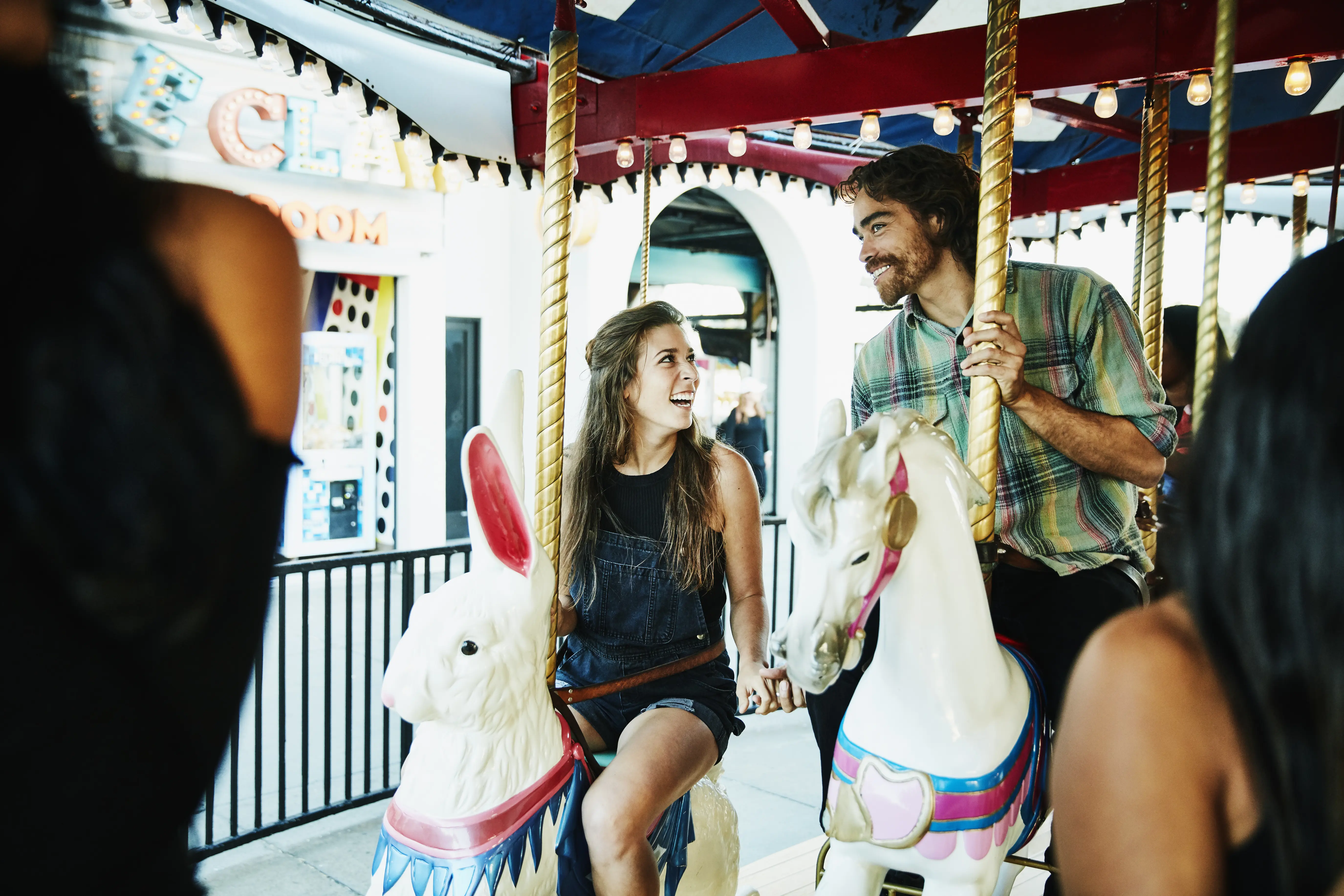 Image of a couple on carousel together.