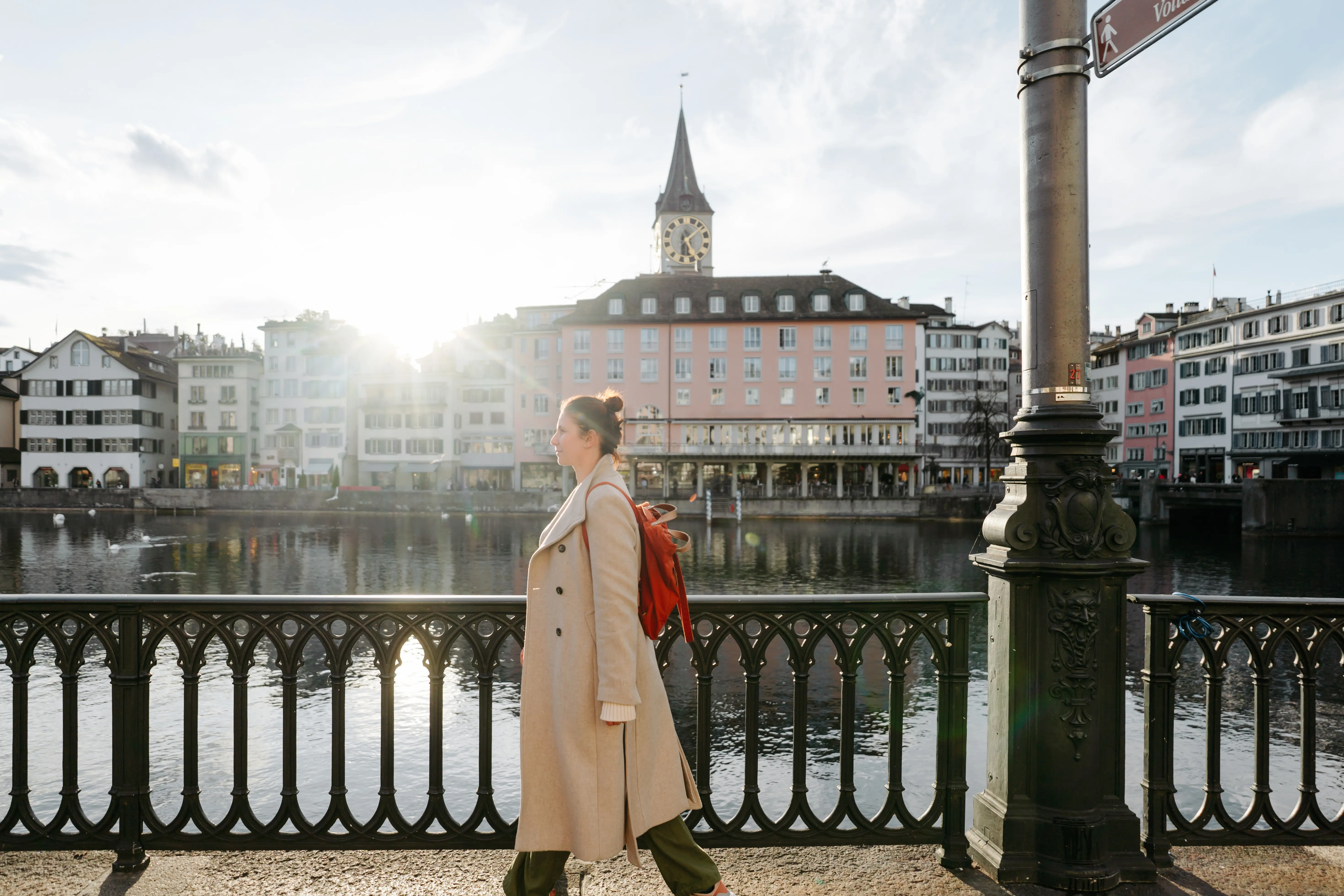Image of a woman walking the cobblestone streets and discovering sights of Zurich.