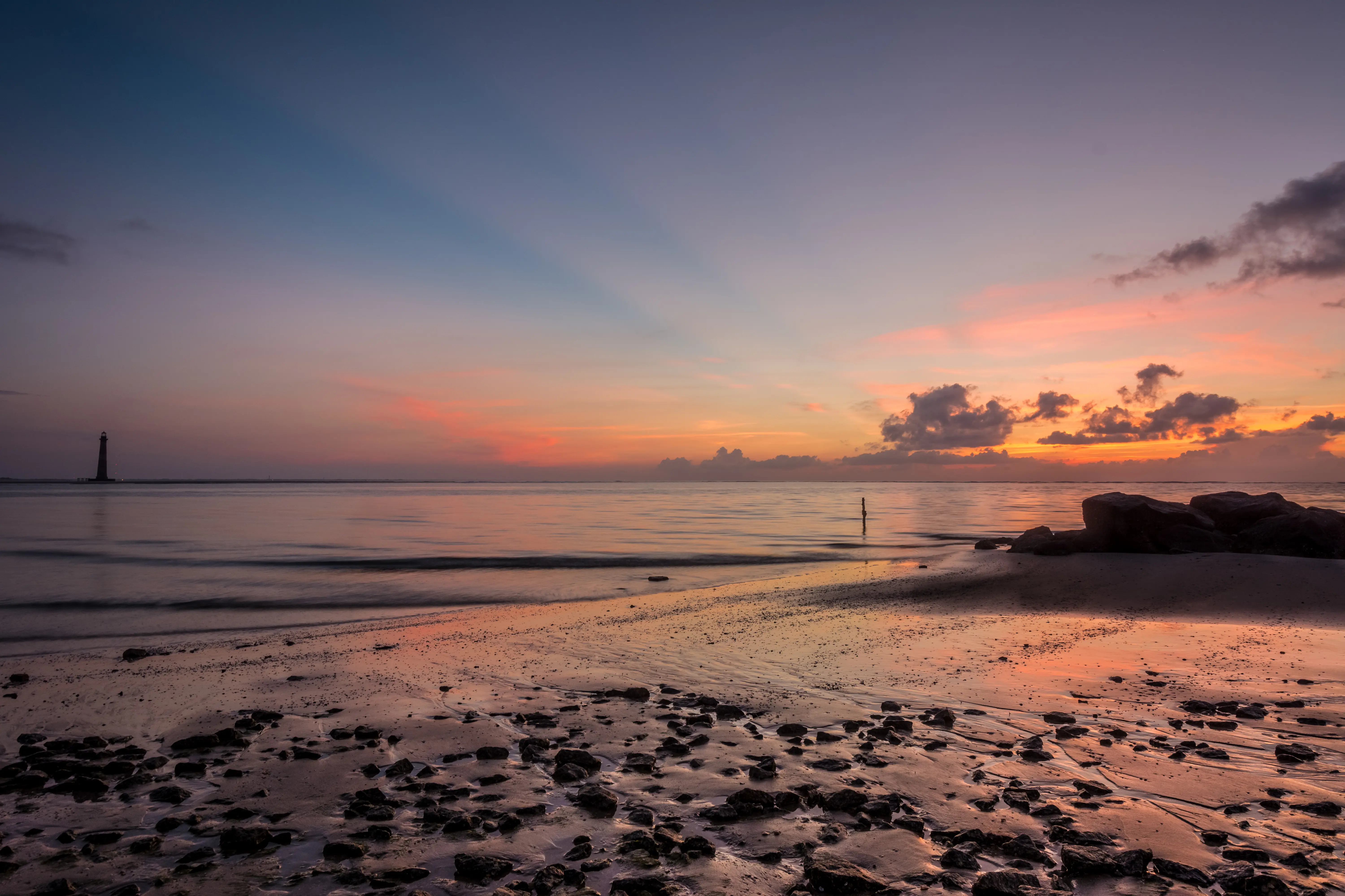 Image of Morris Island beach, and the distant lighthouse.