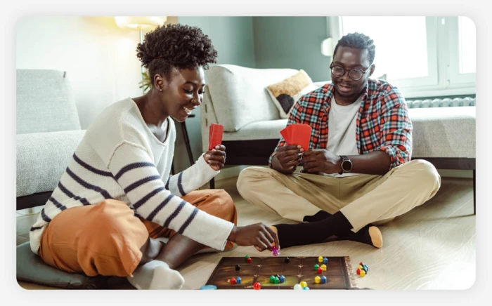 A couple sitting down and playing a board game