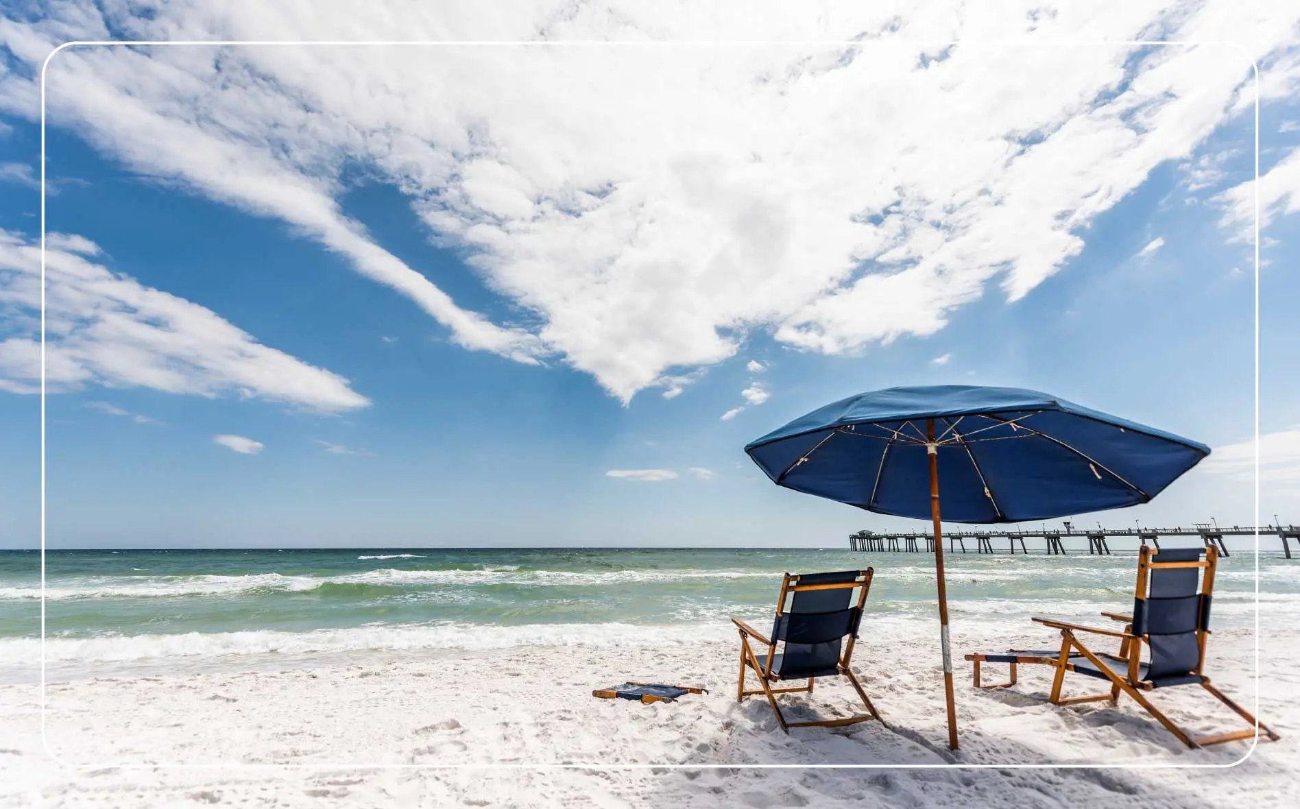 A couple of beach chairs with an umbrella on Fort Walton Beach.