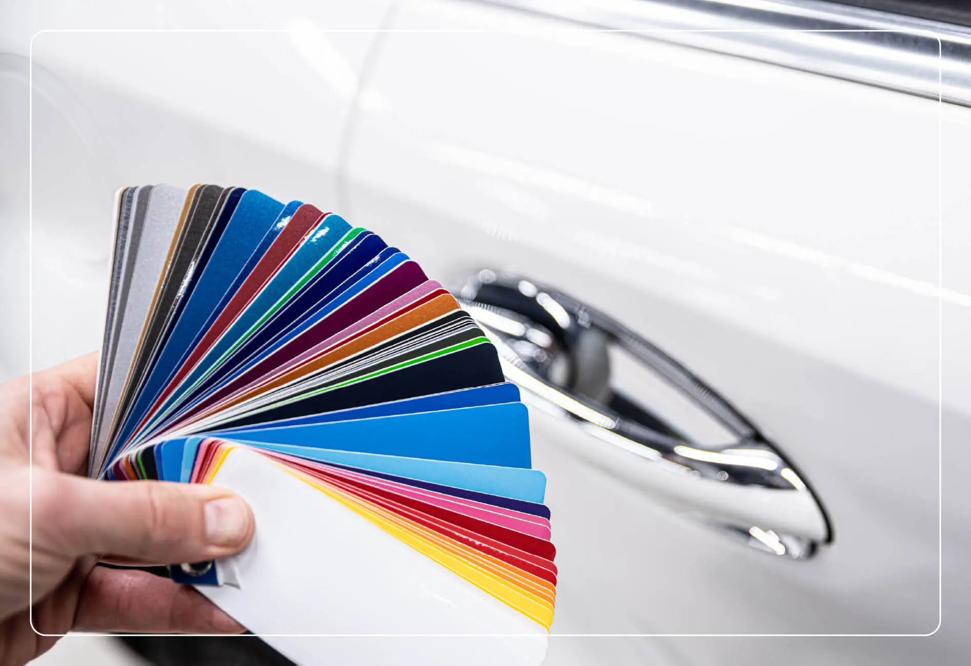 Someone holding a batch of vehicle color swatches.