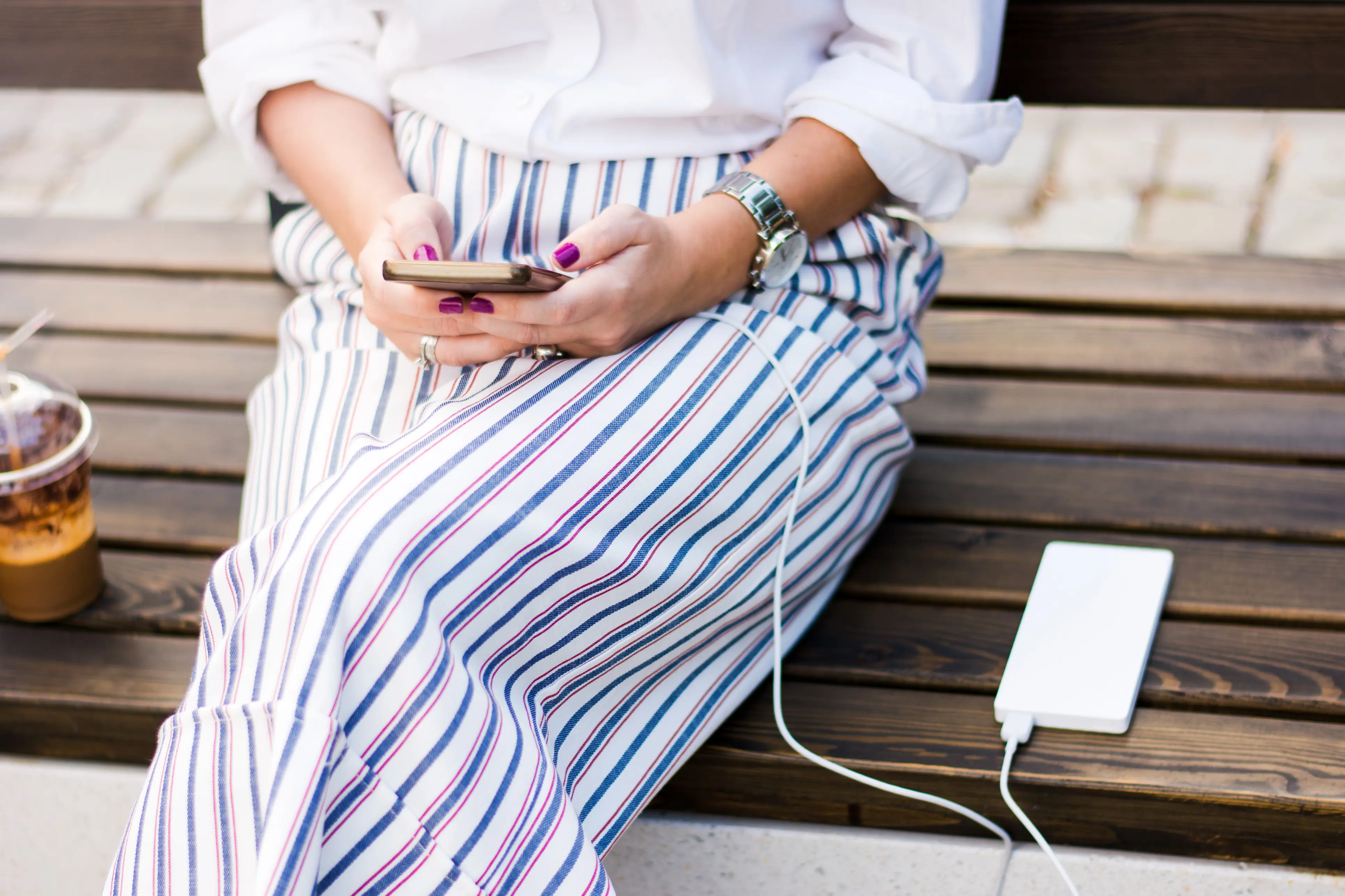 Woman using phone with charger and power bank