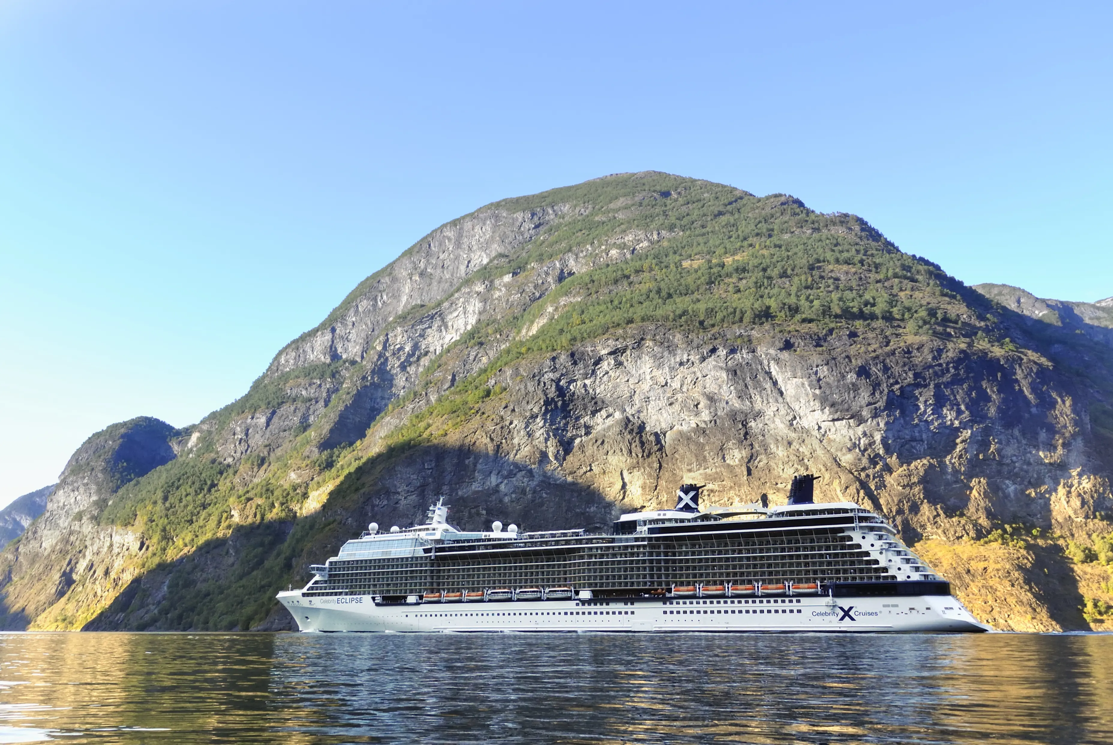 Image of a Celebrity cruise ship sailing through the Aurlandsfjord in Norway.
