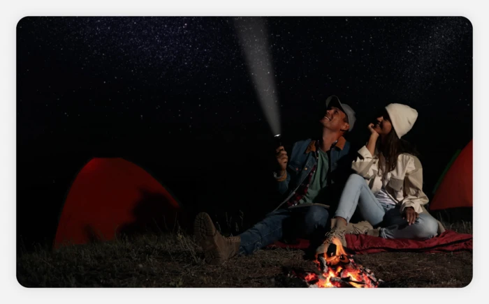 A couple stargazing at a campground